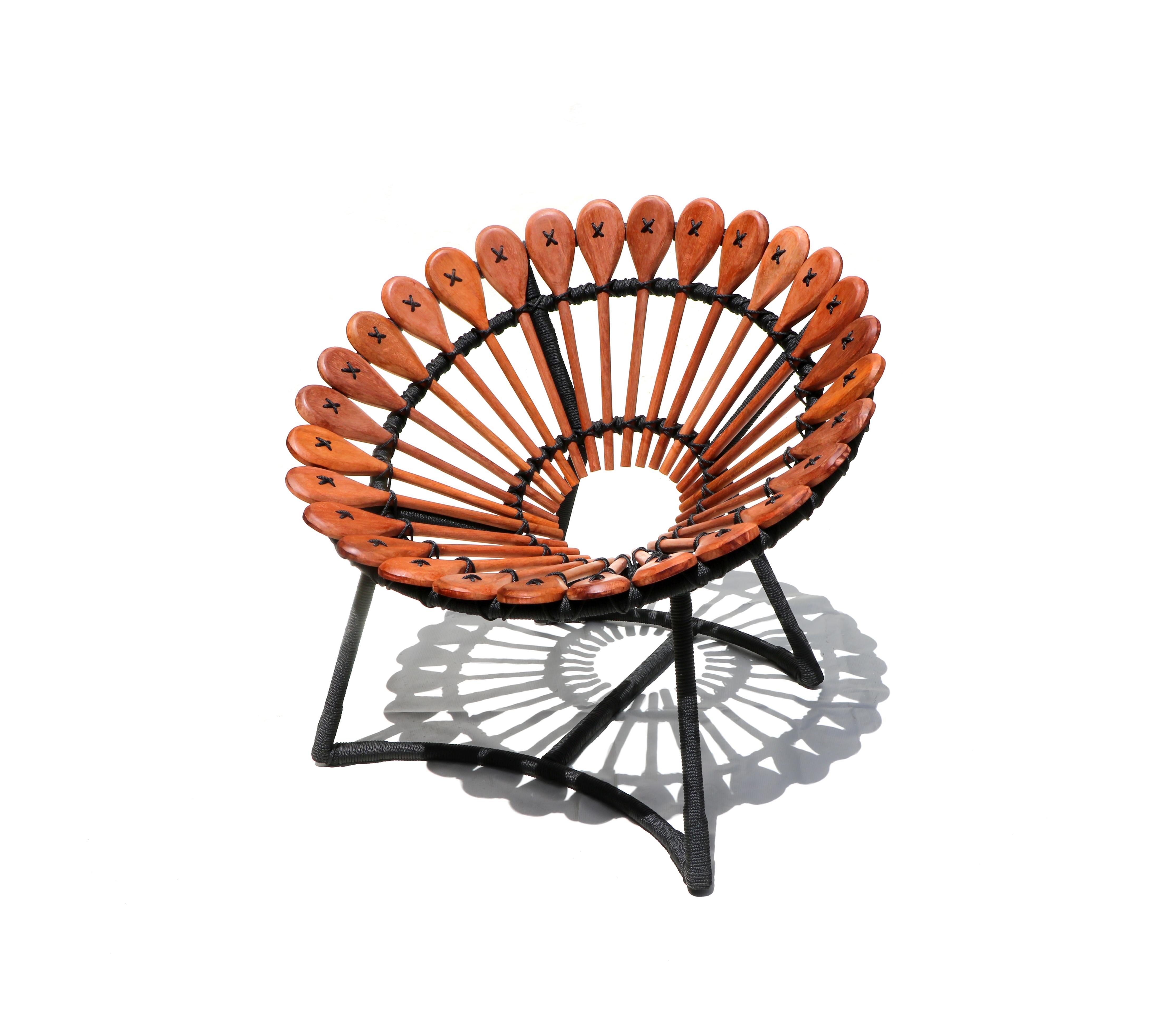 This lounge chair, in a Brazilian contemporary design, is made of carbon steel, wood, and rope. 

The lounge chair is inspired by the elements of the free market of Campina Grande at Paraíba.