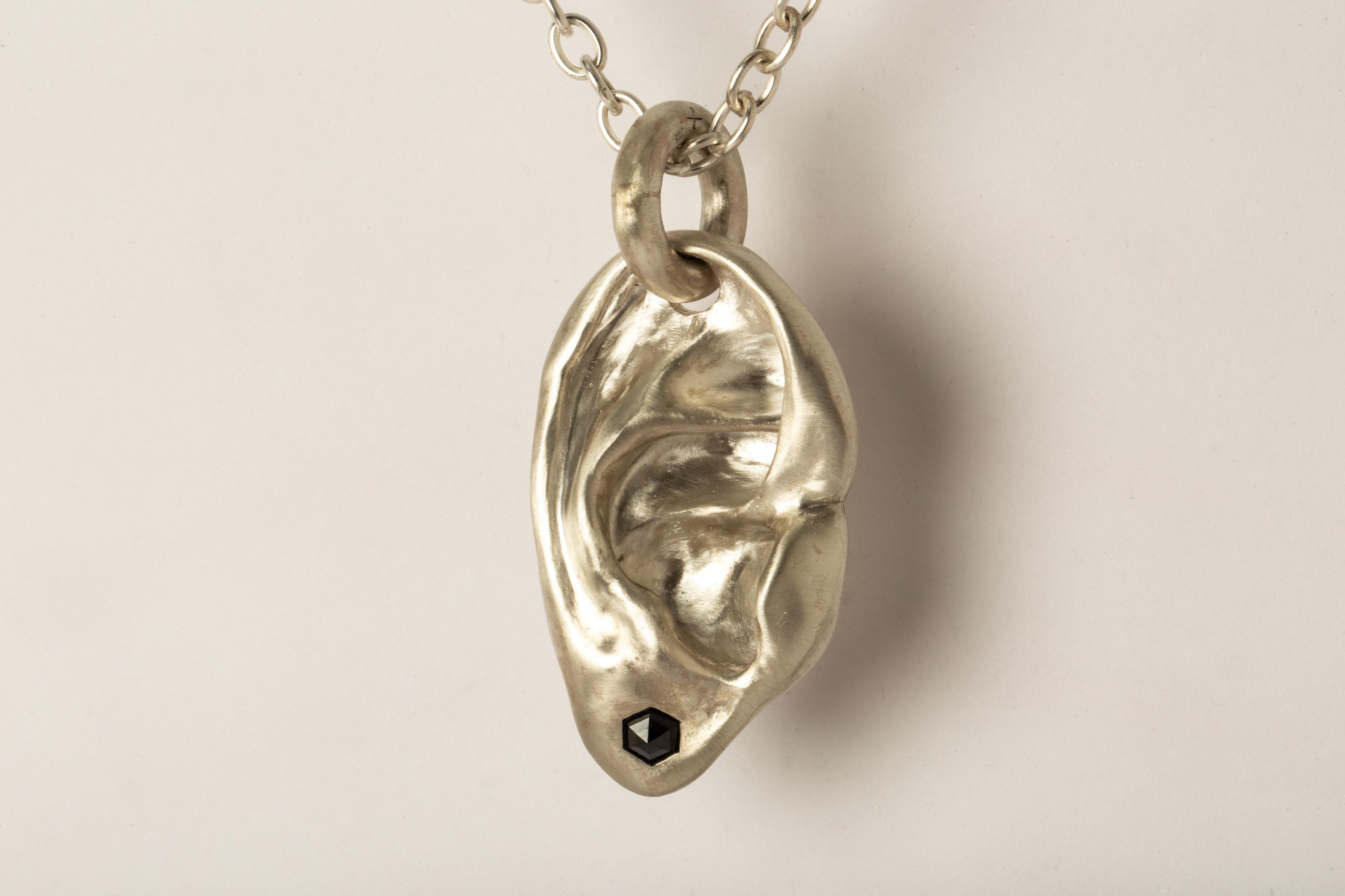Pendant necklace in the shape of body part in sterling silver and a slab of black Hex shaped black diamond, it comes on a 74cm chain. This slab is removed from a larger chunk of diamond. This item is made with a naturally occurring element and will