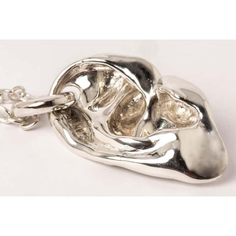 Pendant necklace in the shape of body part in polished sterling silver, it comes on a 74cm chain. 