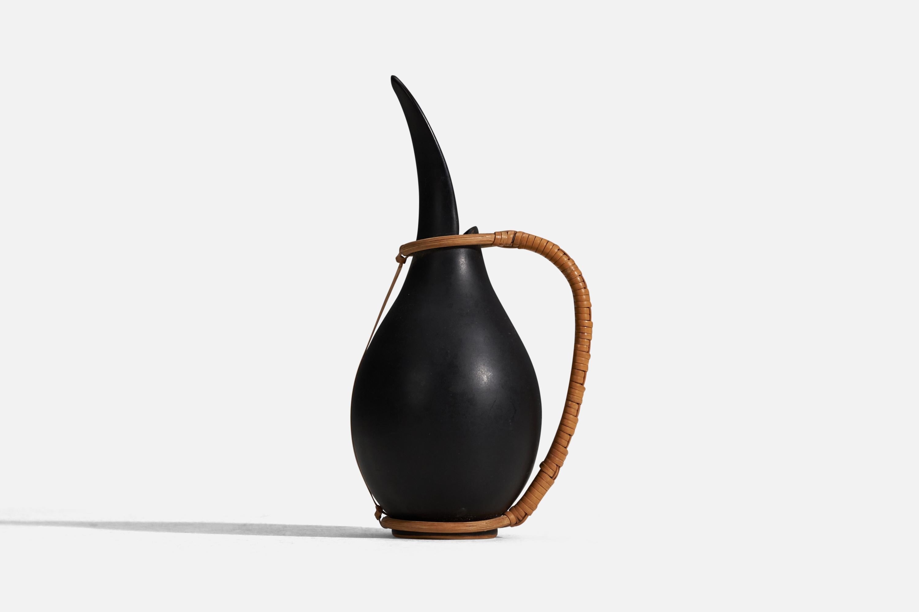 A black glazed stoneware and rattan pitcher designed and produced by Bofa Keramik, Bornholm, Denmark, 1960.
