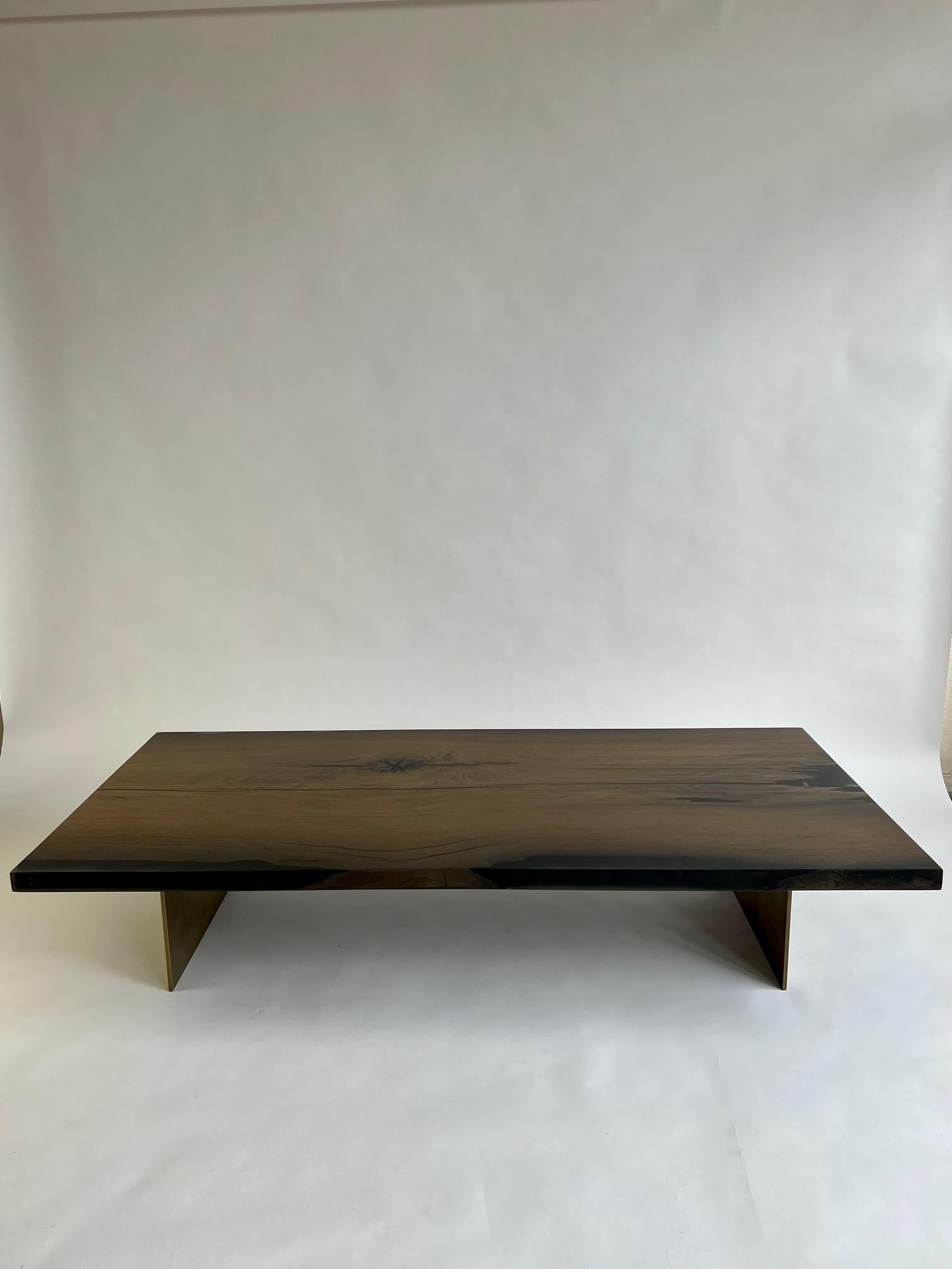 Introducing an extraordinary coffee table crafted from ancient Bog Oak and durable epoxy resin. This remarkable piece is made from wood that is an astonishing 7,000 years old, sourced from Romania. The wood's exceptional preservation can be