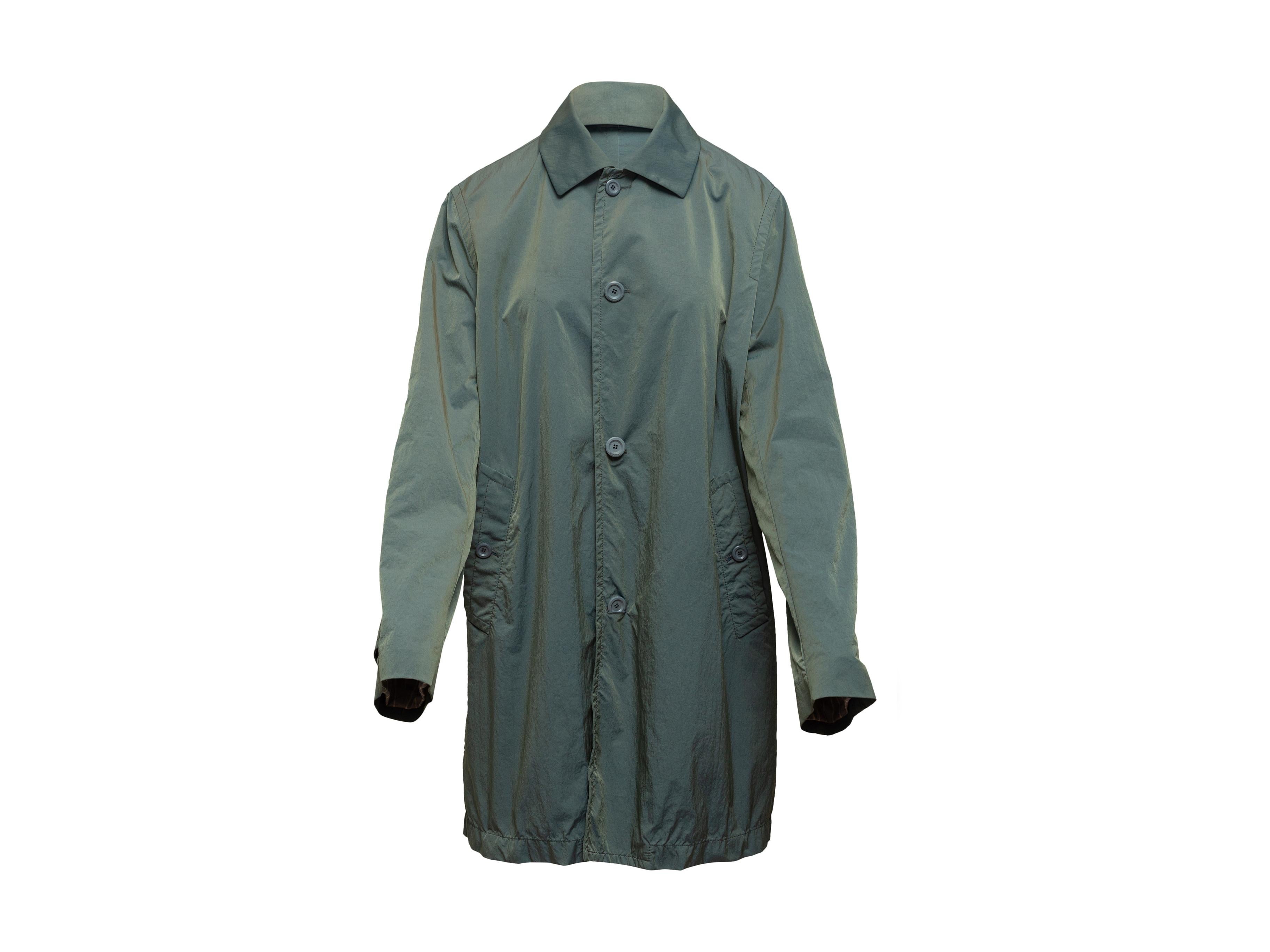 Product details: Sage green nylon coat by Boglioli. Pointed collar. Dual hip pockets. Button closures at center front. 36