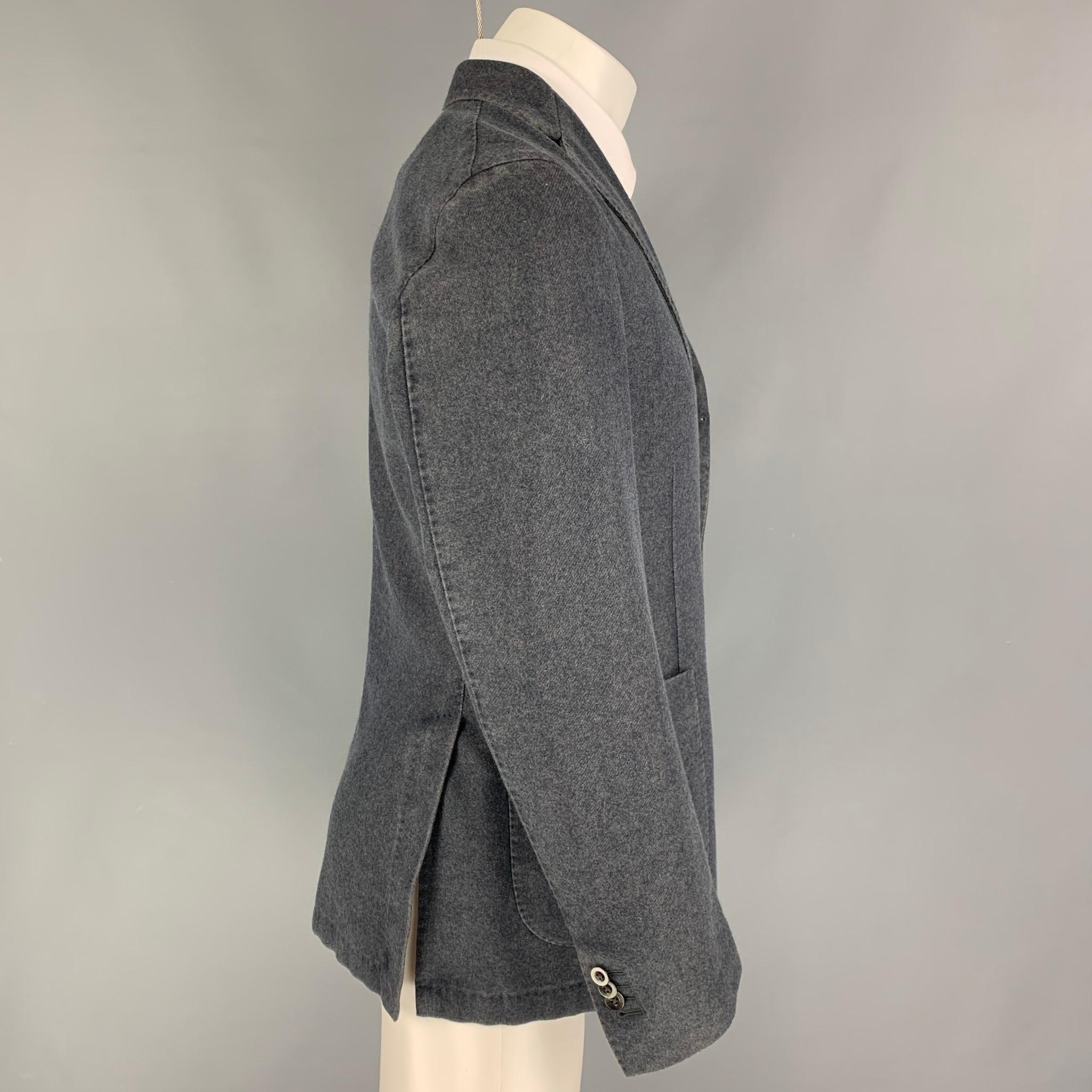 BOGLIOLI sport coat comes in a grey heather wool / polyester featuring a notch lapel, patch pockets, and a double button closure. Made in Italy. 

Very Good Pre-Owned Condition.
Marked: 48

Measurements:

Shoulder: 17.5 in.
Chest: 38 in.
Sleeve: 26