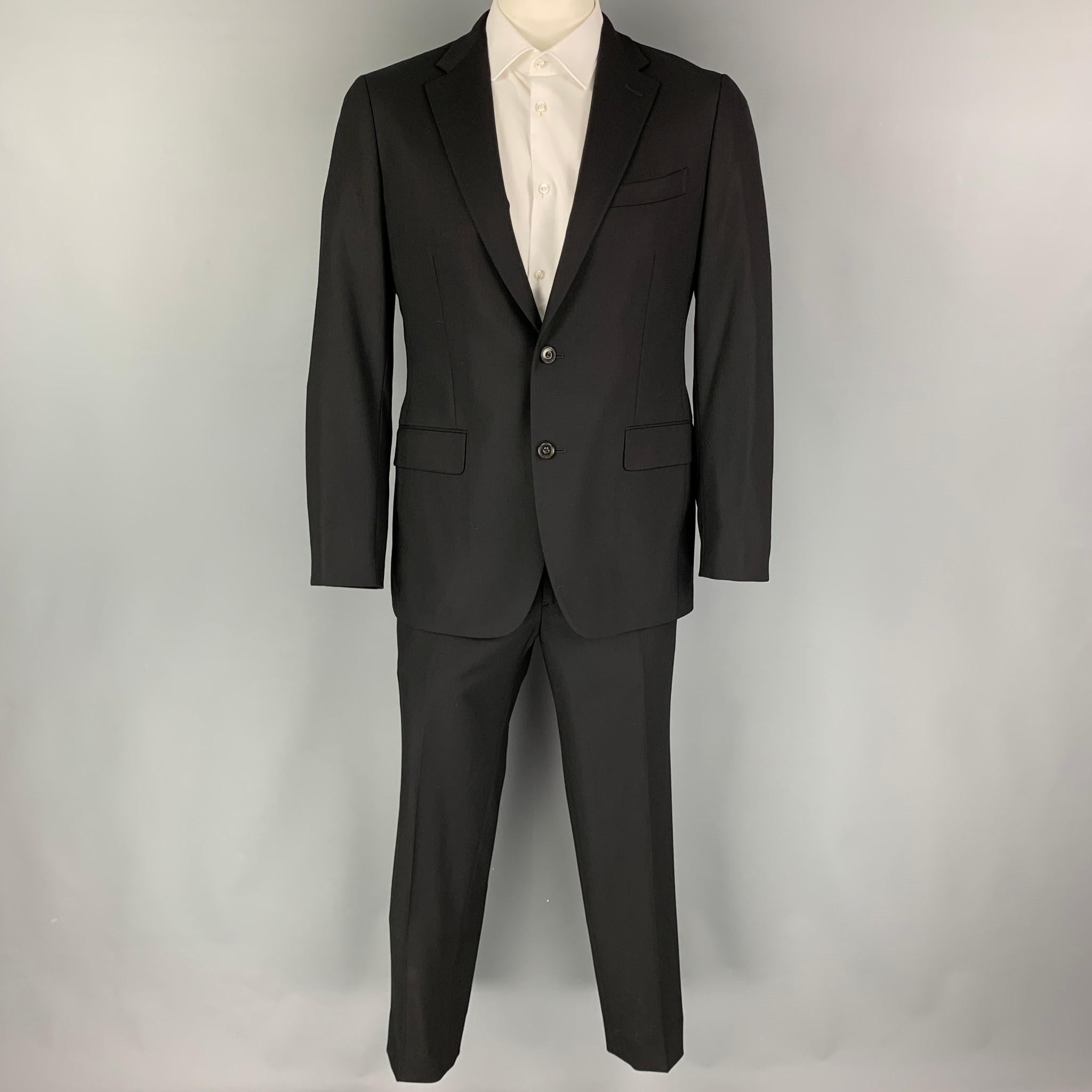 BOGLIOLI suit comes in a black wool with a full liner and includes a single breasted, double button sport coat with a notch lapel and matching flat front trousers.

Very Good Pre-Owned Condition.
Marked: 52

Measurements:

-Jacket
Shoulder: 18
