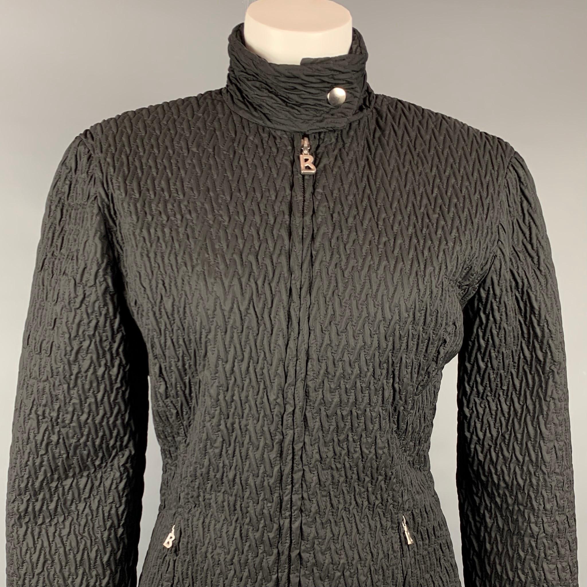 BOGNER jacket comes in a black textured quilted nylon featuring a buttoned collar, silver tone hardware, and a full zip closure. Made in USA.

Very Good Pre-Owned Condition.
Marked: 6
Original Retail Price: $650.00

Measurements:

Shoulder: 18