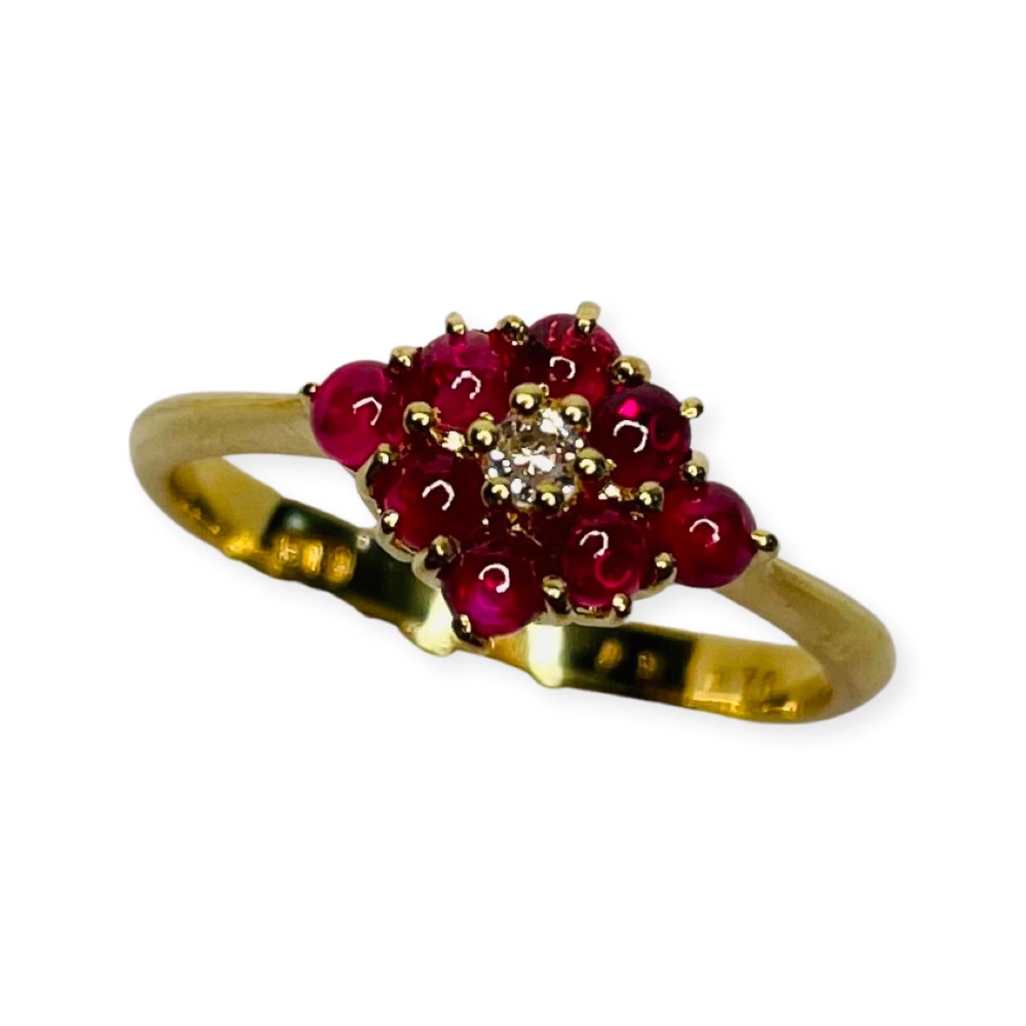 Bogo 18K Yellow Gold Ring with Natural Ruby Cabochons and Diamonds.  The ring has 8- 0.70 carats of cabochon cut rubies.  There is 1- 0.03 carat, full cut round brilliant diamond, of SI clarity and GH color. 6 prong set in the center of the rubies.