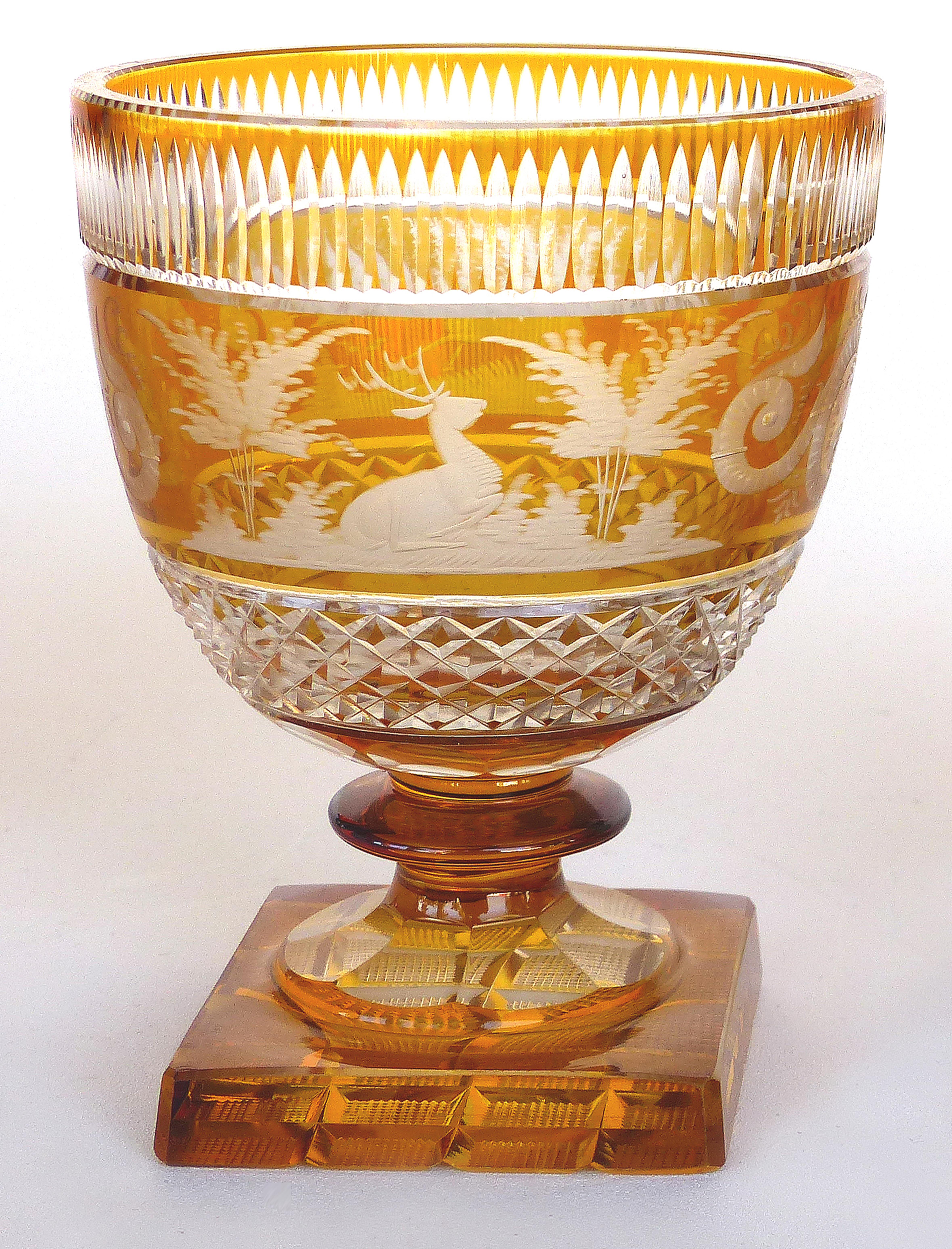 Offered for sale a fine pair of Bohemia glass amber to clear crystal goblets with finely etched designs. These heavy, well made goblets have designs with stags and foliage.