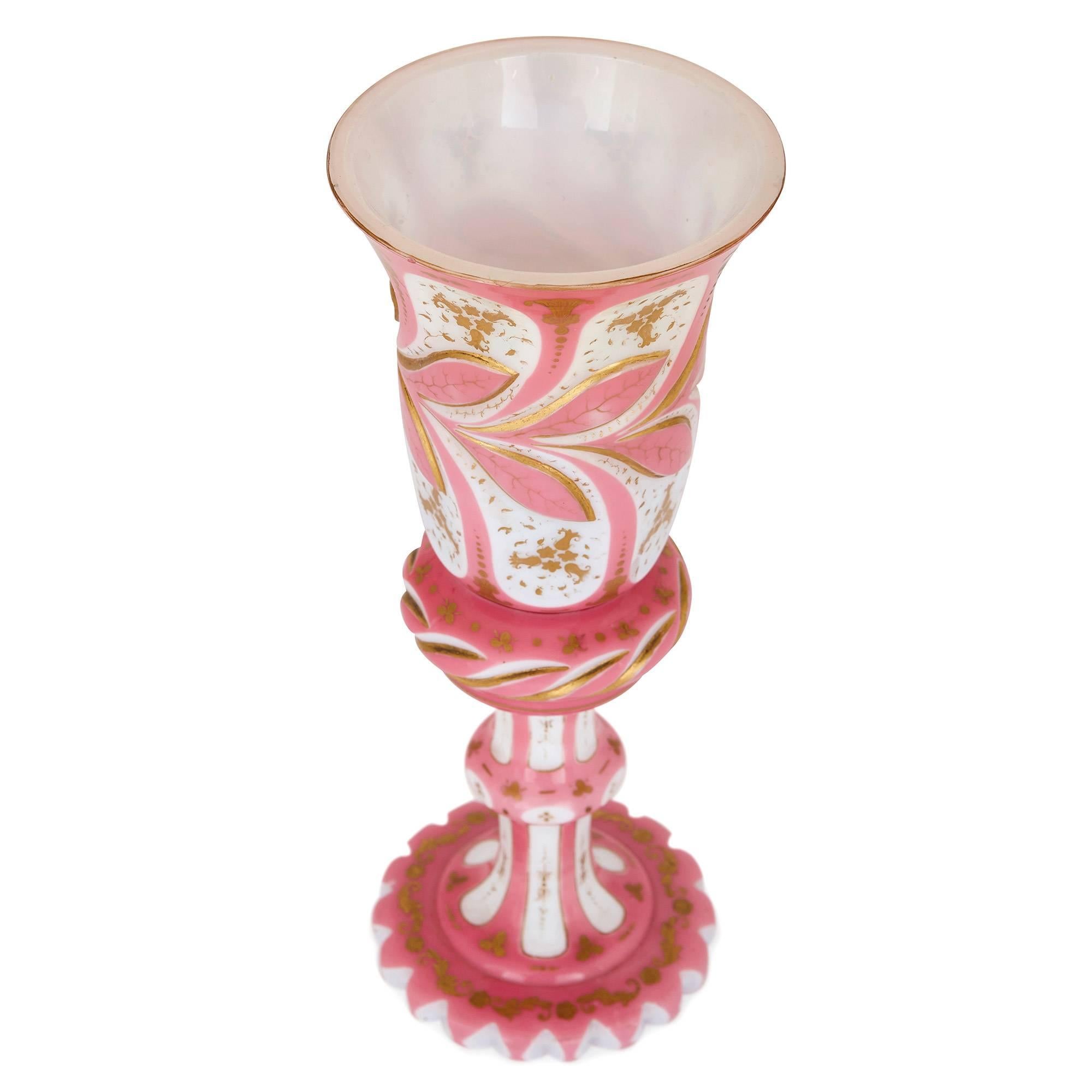 This beautiful, precious cup represents some of the best in Bohemian glass design in the 19th century. It was the Bohemian glass makers in the 19th century who perfected the technically challenging technique of glass overlay, which involves placing