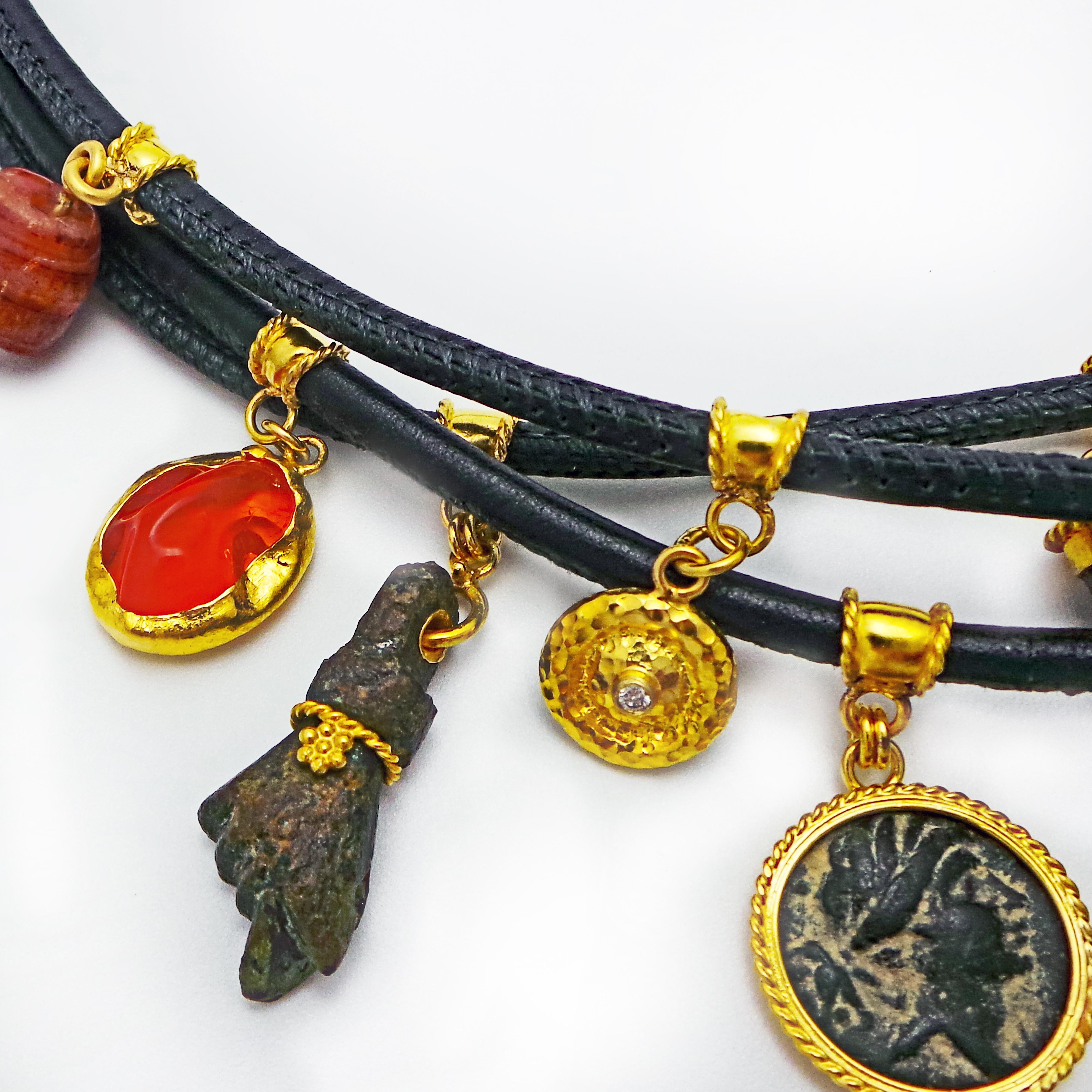 Bohemian 3-strand black, round-stitched leather necklace with ancient Roman bronze artifacts, ancient chalcedony and agate beads, Mexican fire opal, solid 22k yellow gold Ixthus charm, and hammered 22k gold and diamond charm. Ancient Roman bronze