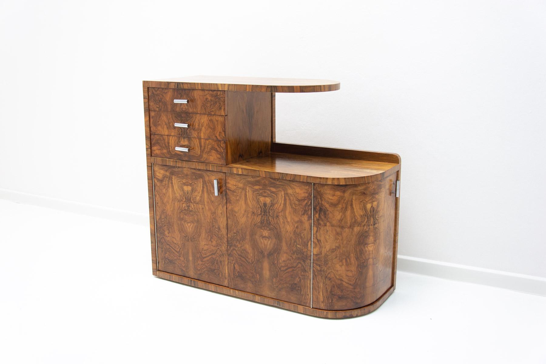 This ART DECO bar or sideboard was made in the 1930´s in the former Czechoslovakia.

It´s charakterized a very simple and practical design. Consists of two storage spaces with opening doors and three drawers.
It´s a beautiful example of Central