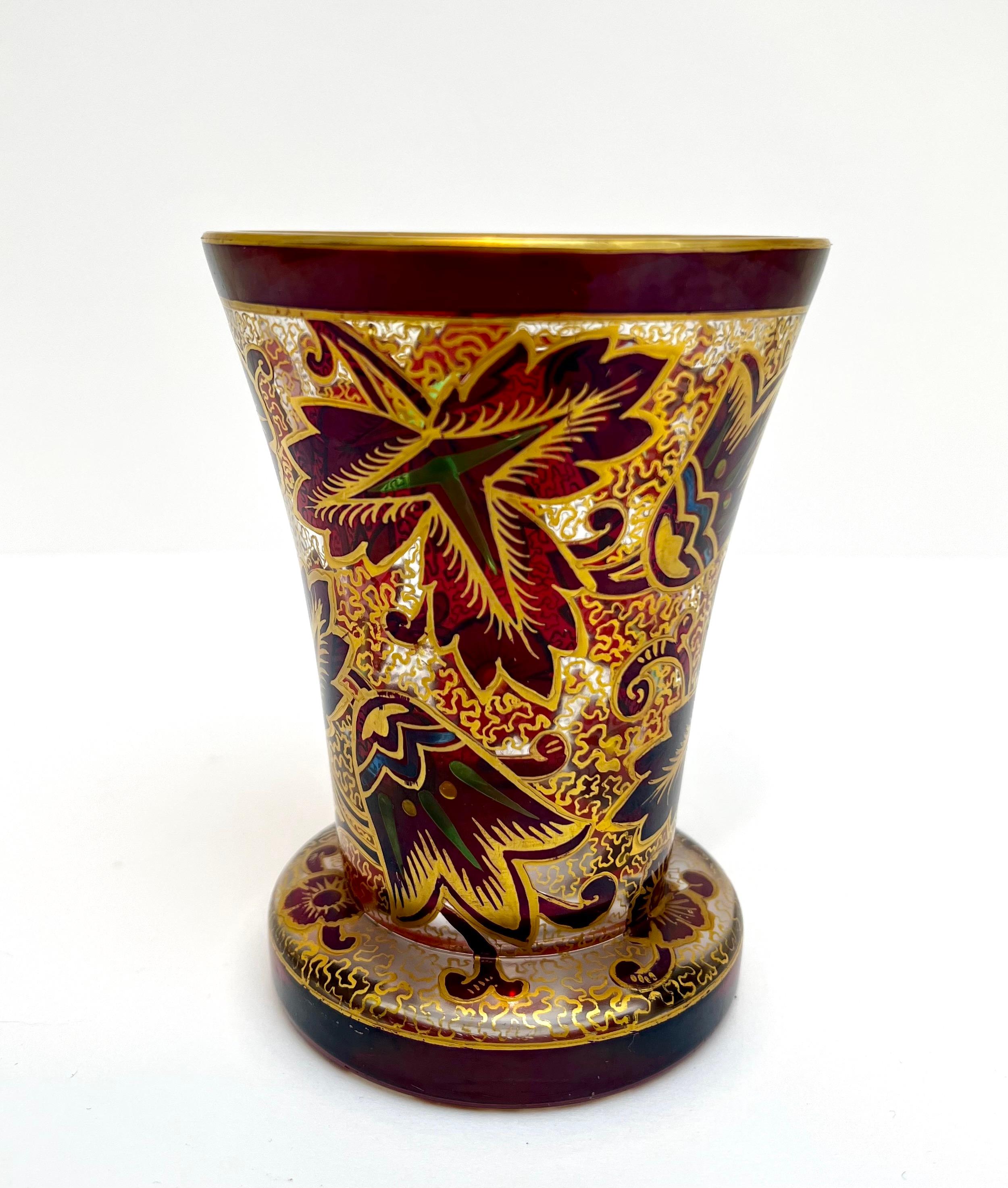 A superb unmatched pair of Art Nouveau Bohemian art glass vases or beakers by Julius Mulhaus & Co, Haida. The thickly made shaped rounded glass vase is decorated in a stained glass window style with floral designs on one beaker. And a vibrant