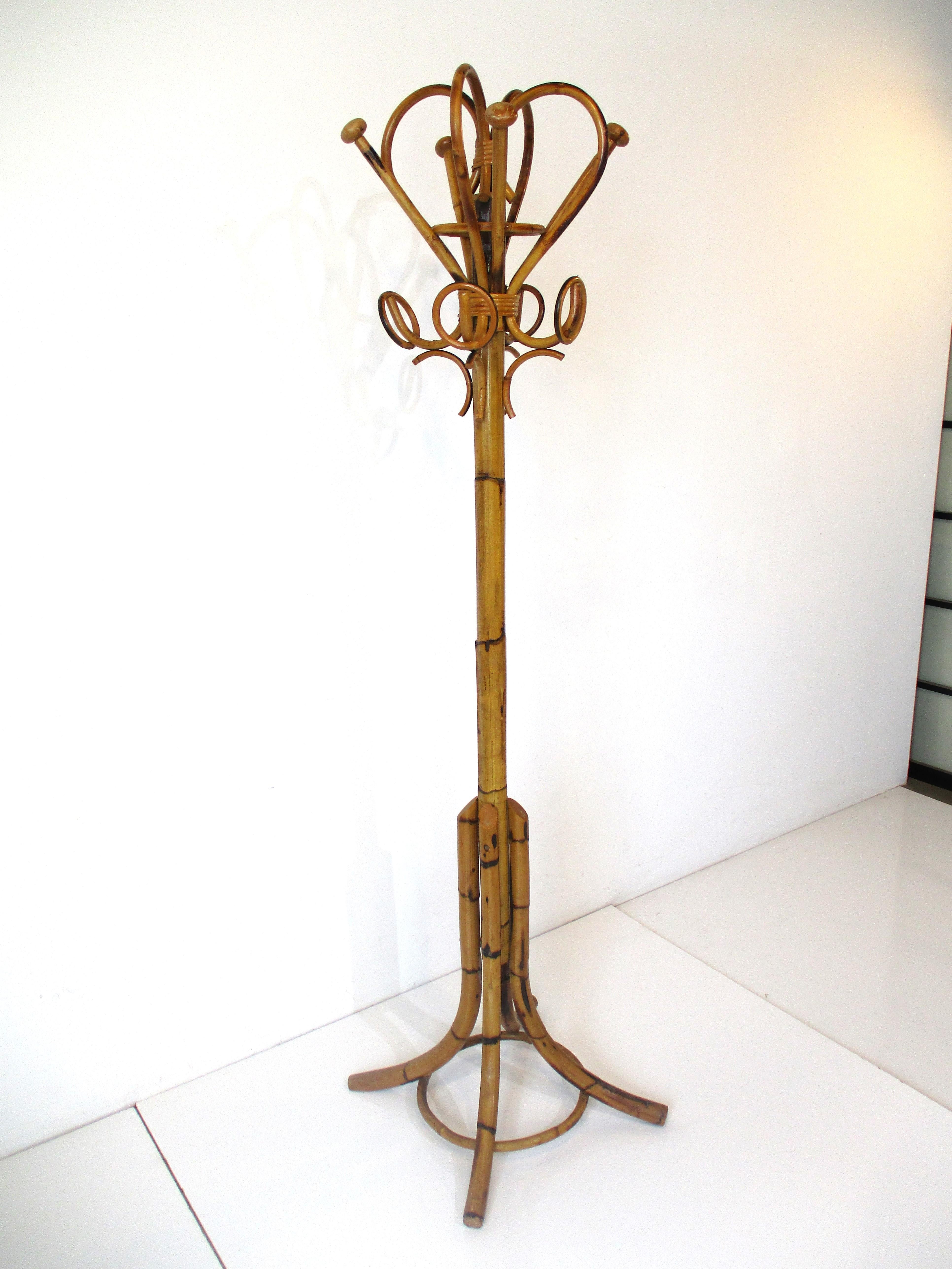 A bent sculptural bamboo coat and hat rack in the style of Franco Albini with darker toned detail to the top, shaft and bottom. Great for that entrance way or just by the door, pictured is a signature to the bottom rim 