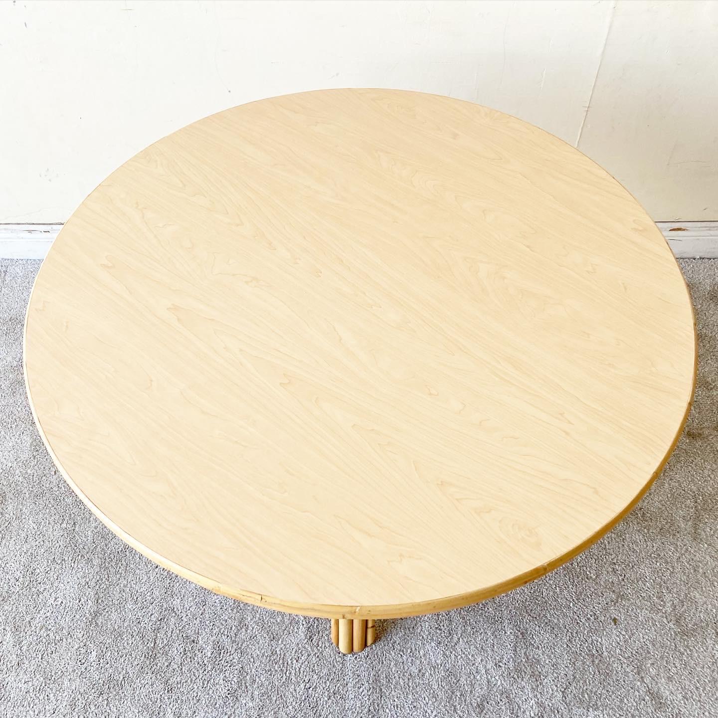 Exceptional vintage boho chic circular dining table. Features a bamboo rattan base and a laminate circular top.
 