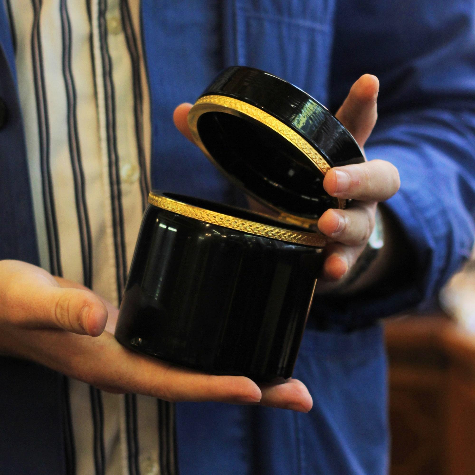 A black amethyst glass lidded vessel with ormolu mounts made in Bohemia (Modern Day Czech Republic), circa 1900. Although made 120 years ago, the piece's minimal design is timeless with perfect proportions and restrained ornamentation. The piece