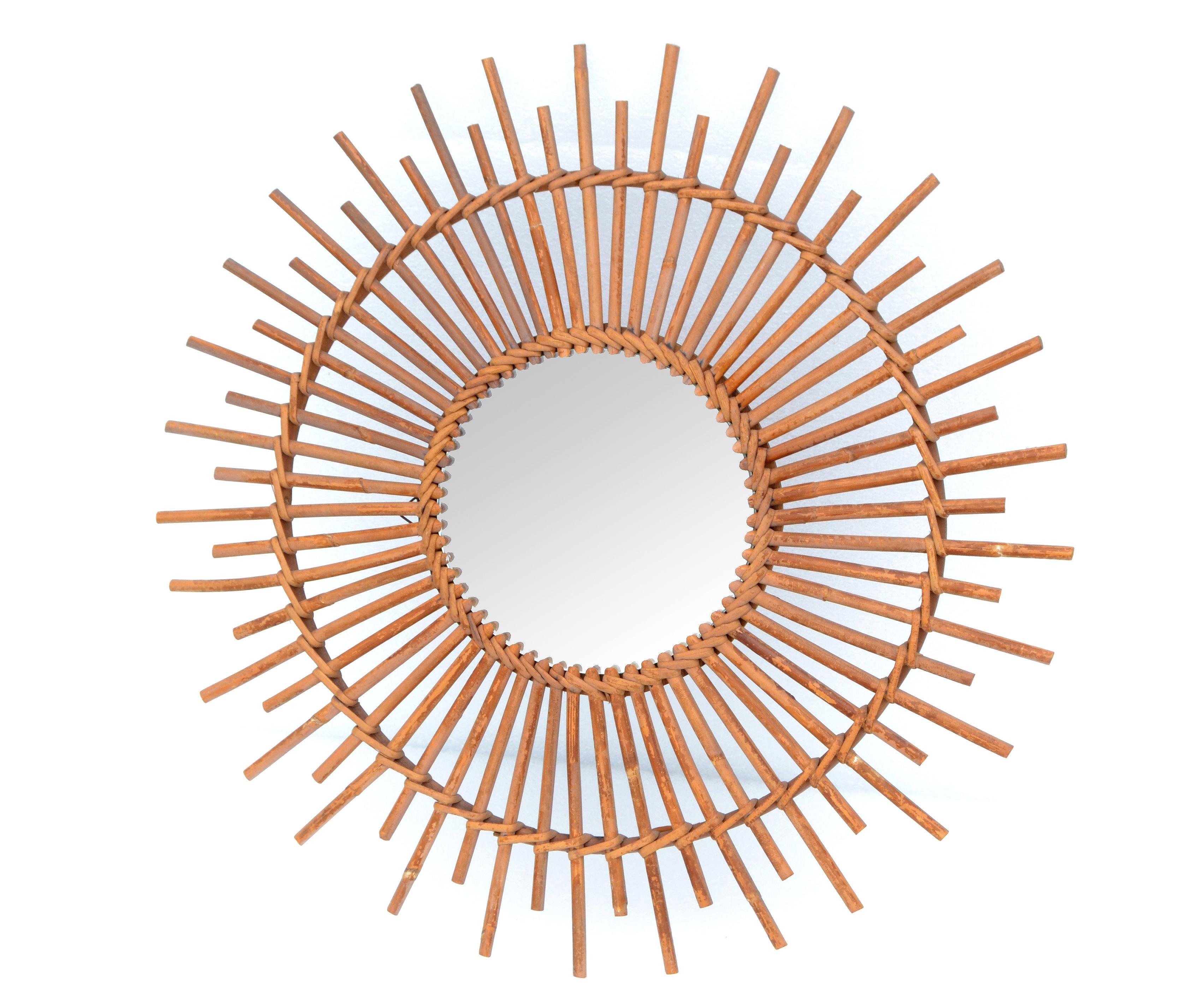 French boho chic round handcrafted wall mirror made out of ficks reed and woven by Wicker.
Made in France in the 1970s.
Diameter of mirror glass measures 8 inches.
Mid-Century Modern design for your sun room.