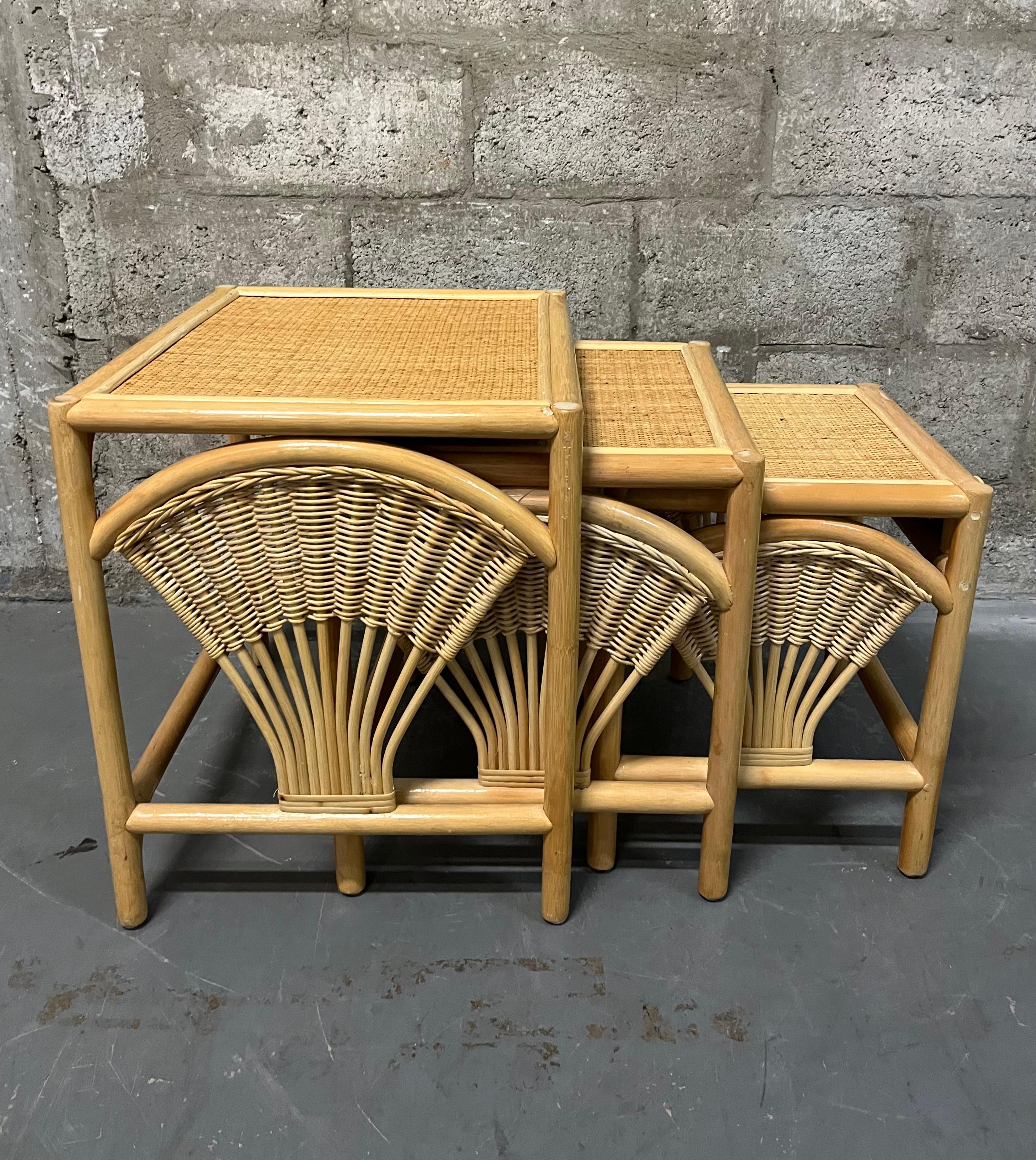 Vintage Coastal Style Bohemian Wheat Sheaf Rattan Nesting Tables. Circa 1980s
Feature a stylish sheaf of wheat design side panels and a beautiful braid trim detail at front in a natural rattan color.
In excellent original condition with very minor