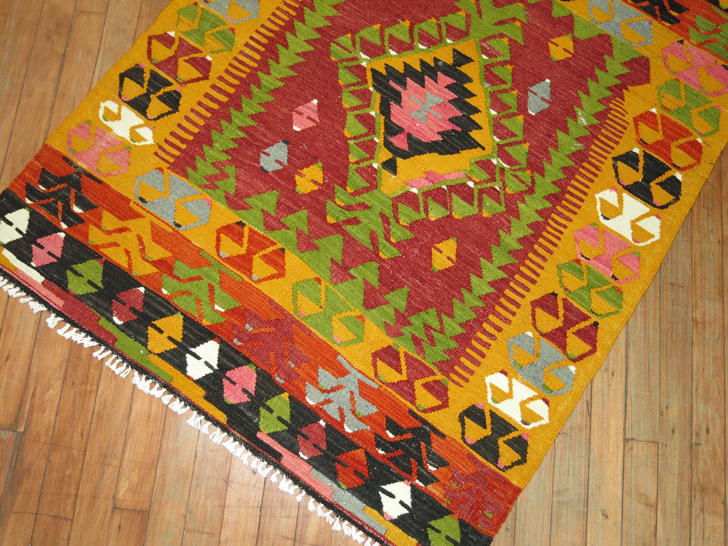 Mid-20th century geometric Turkish Kilim in bright saturated colors. Bright pink, green, red highlight this delightful little gem.

Measures: 3'4