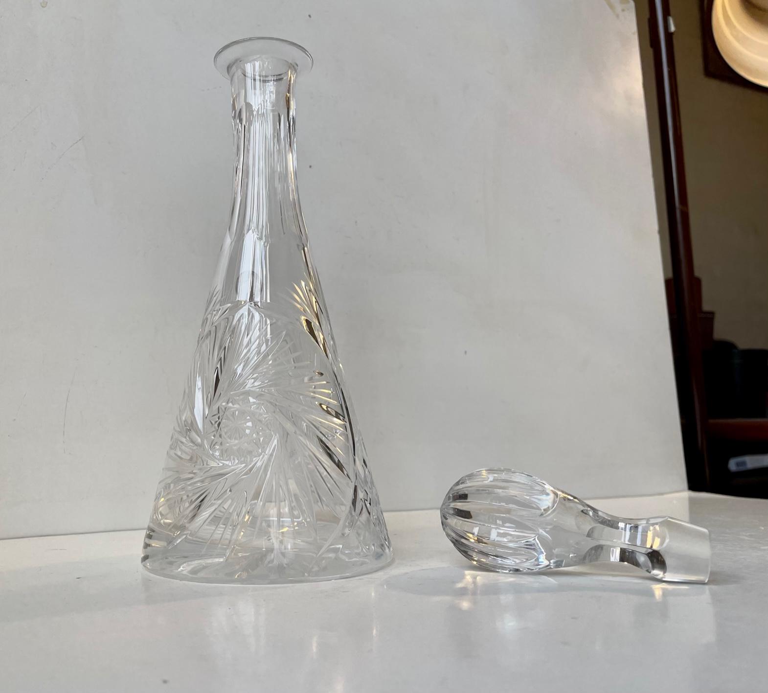 Decorative lead crystal (24%) decanter with fluted spherical stopper. Technique: hand-blown and cut. Made in Bohemia/Czech Republic during the 1960s. It has a capacity of minimum 0.7 liters. Height: 35 cm, D: 12.5 cm.