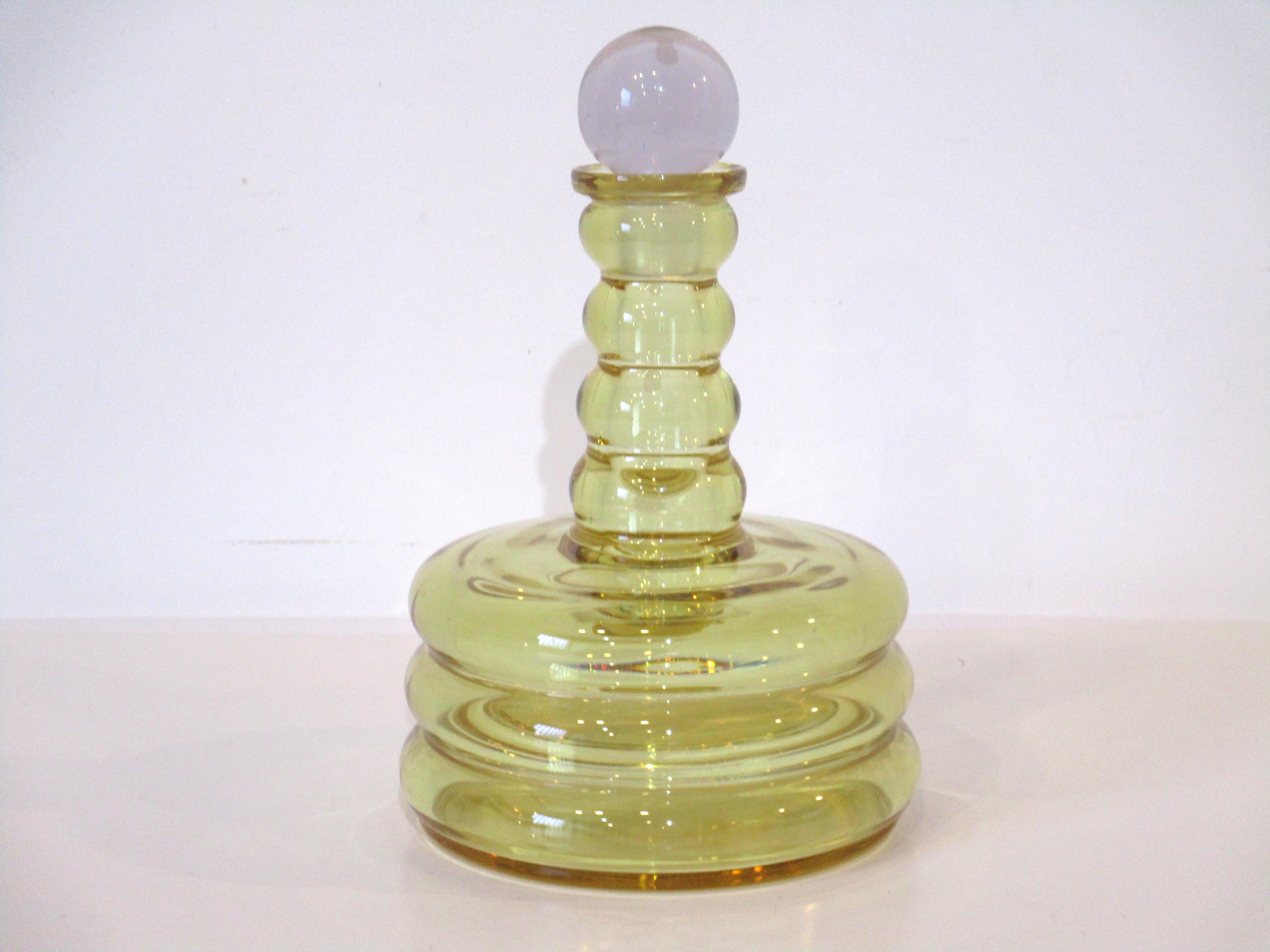 A very well hand crafted heavy quality crystal glass decanter in a amber yellow with a clear stopper. Would be a show piece in any bar or serving area and can be used to hold your favorite bourbon or liqueur.