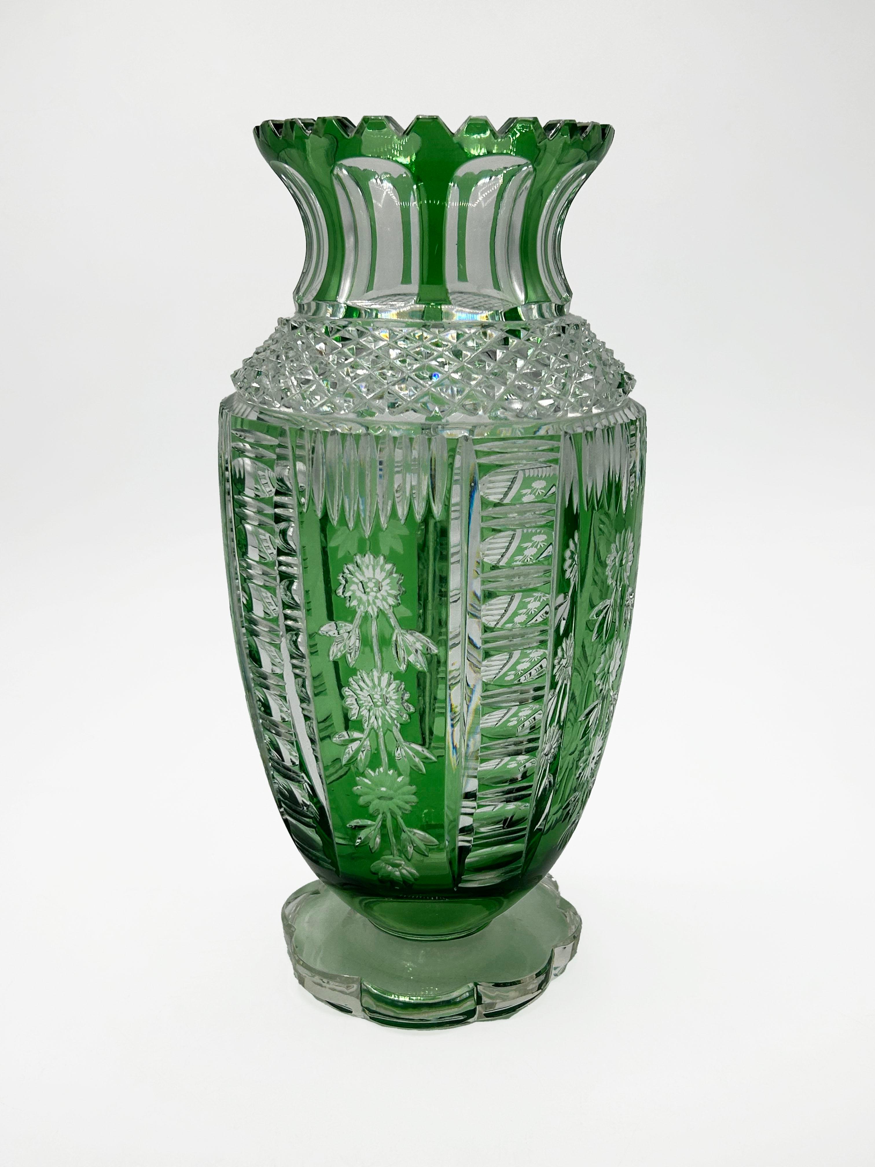 20th Century Bohemian Crystal Vase
This is a 20th-century Bohemian crystal vase, featuring a robust cylindrical body silhouette with a wide, flared neck, set on a lobed base. The vase uses the cased glass technique, with an outer layer of clear