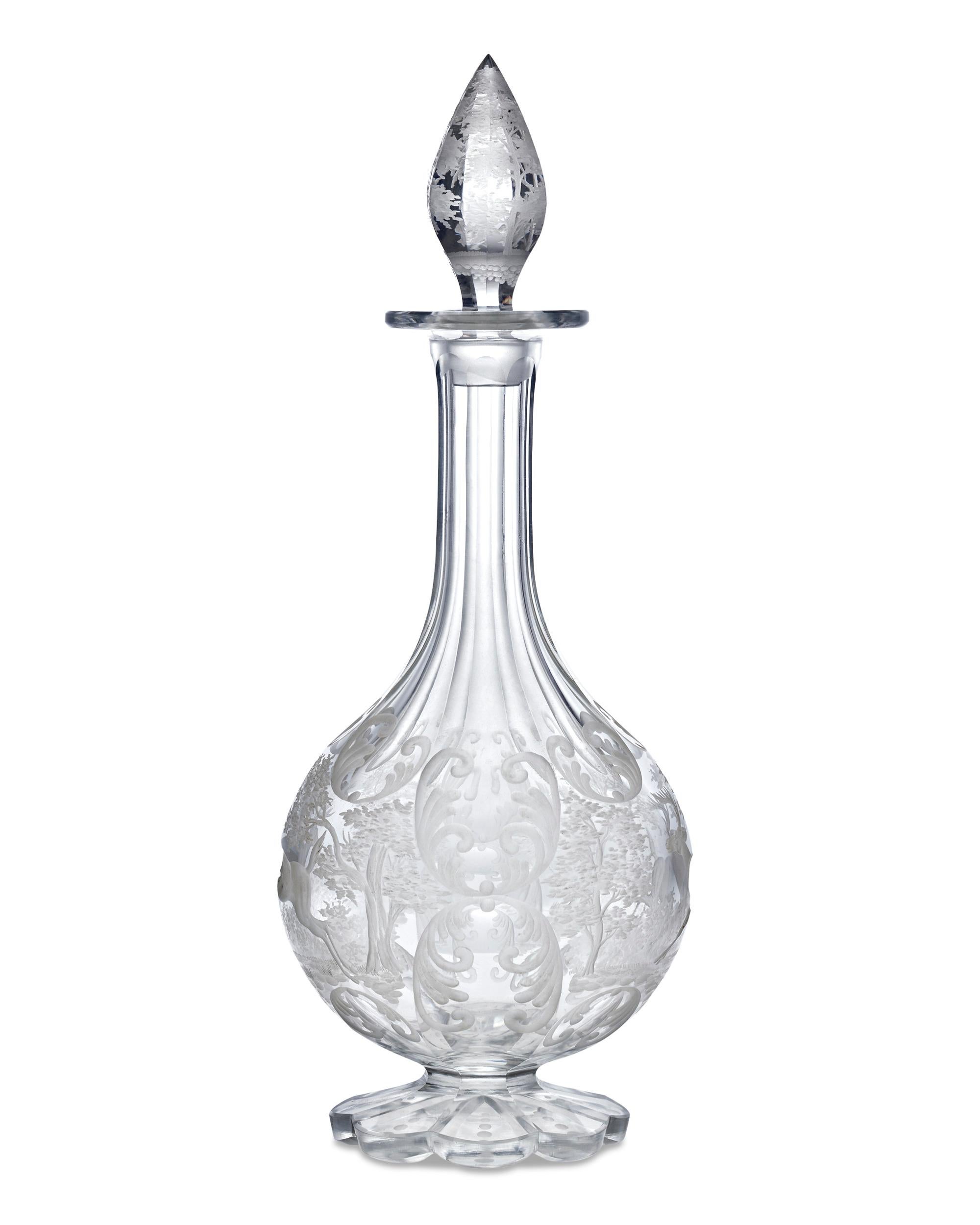 This beautiful Bohemian cut crystal decanter features a continuous, expertly carved engraving of a peaceful woodland scene populated by running stags. Extending from this charming scene is an elongated neck culminating in a beautiful and sizable cut