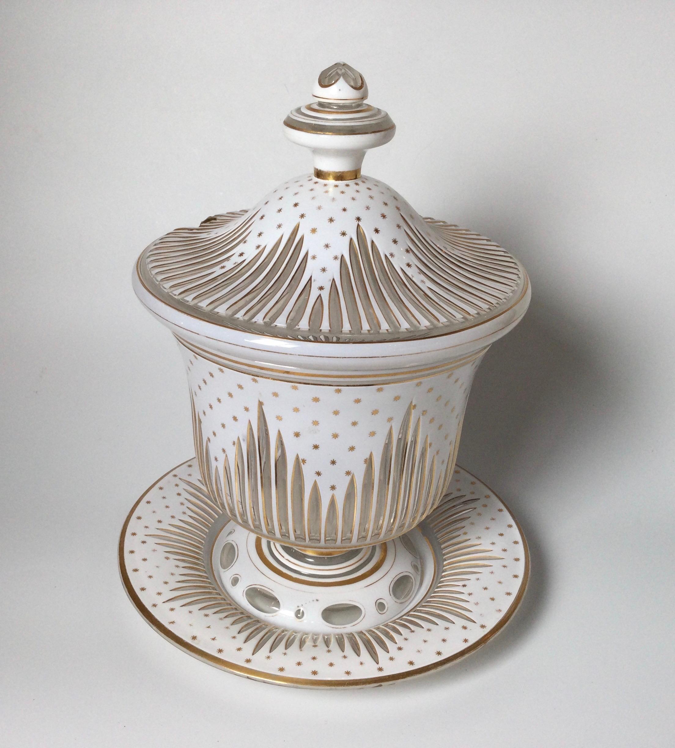 A late 19th Century white and clear glass urn form punch bowl with lid and underplate. The glass with wheel cut lines on all three pieces with gilt decoration throughout . the set measures 13.5 inches tall, the underplate is 11 inches in diameter.