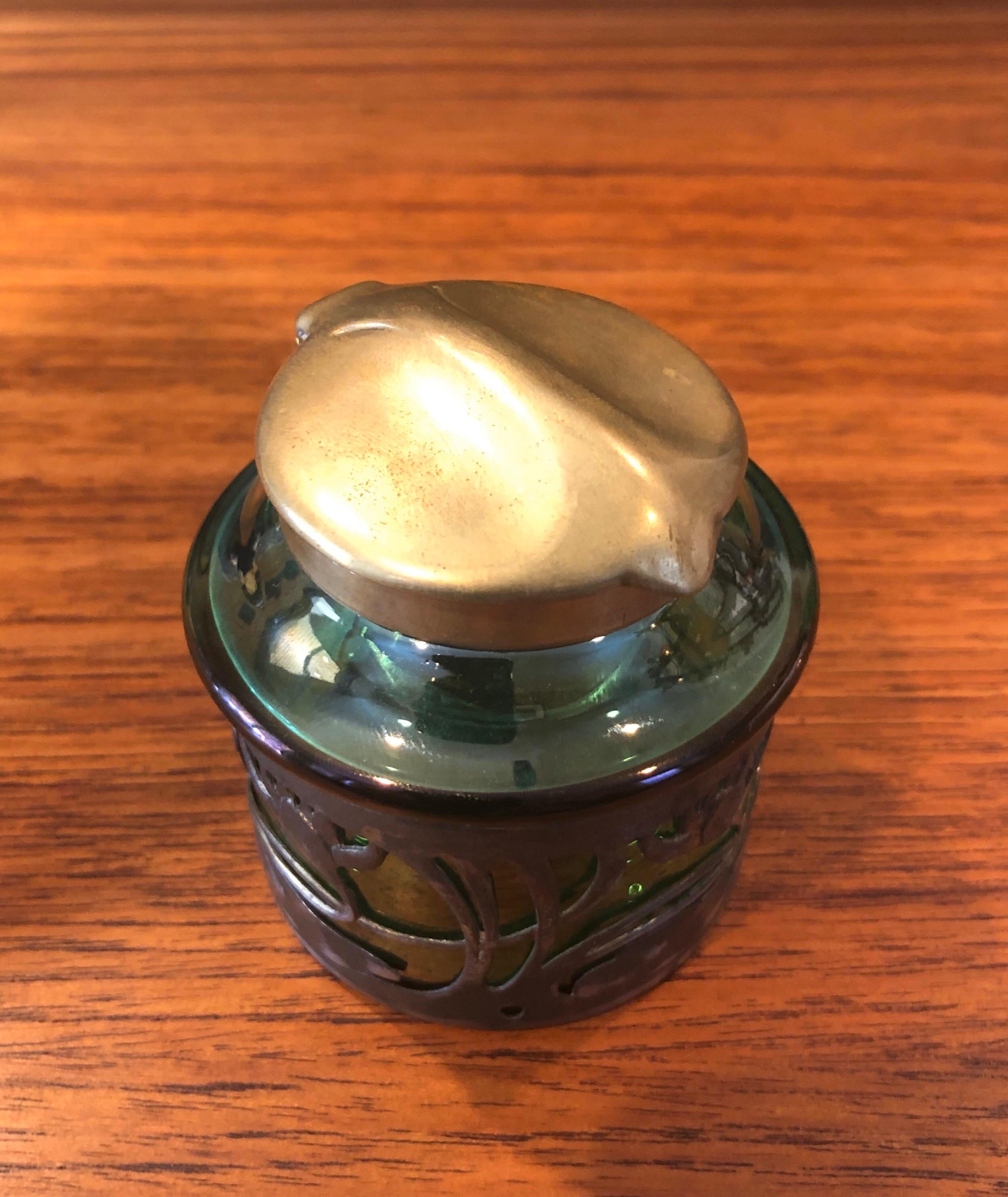 Stunning Bohemian Czech Art Nouveau inkwell with metal water lily overlay in the style of Loetz, circa 1900s. The green art glass well is capped with a gorgeous brass leaf motif lid and rim (there is a serial # or model # in the underside of the