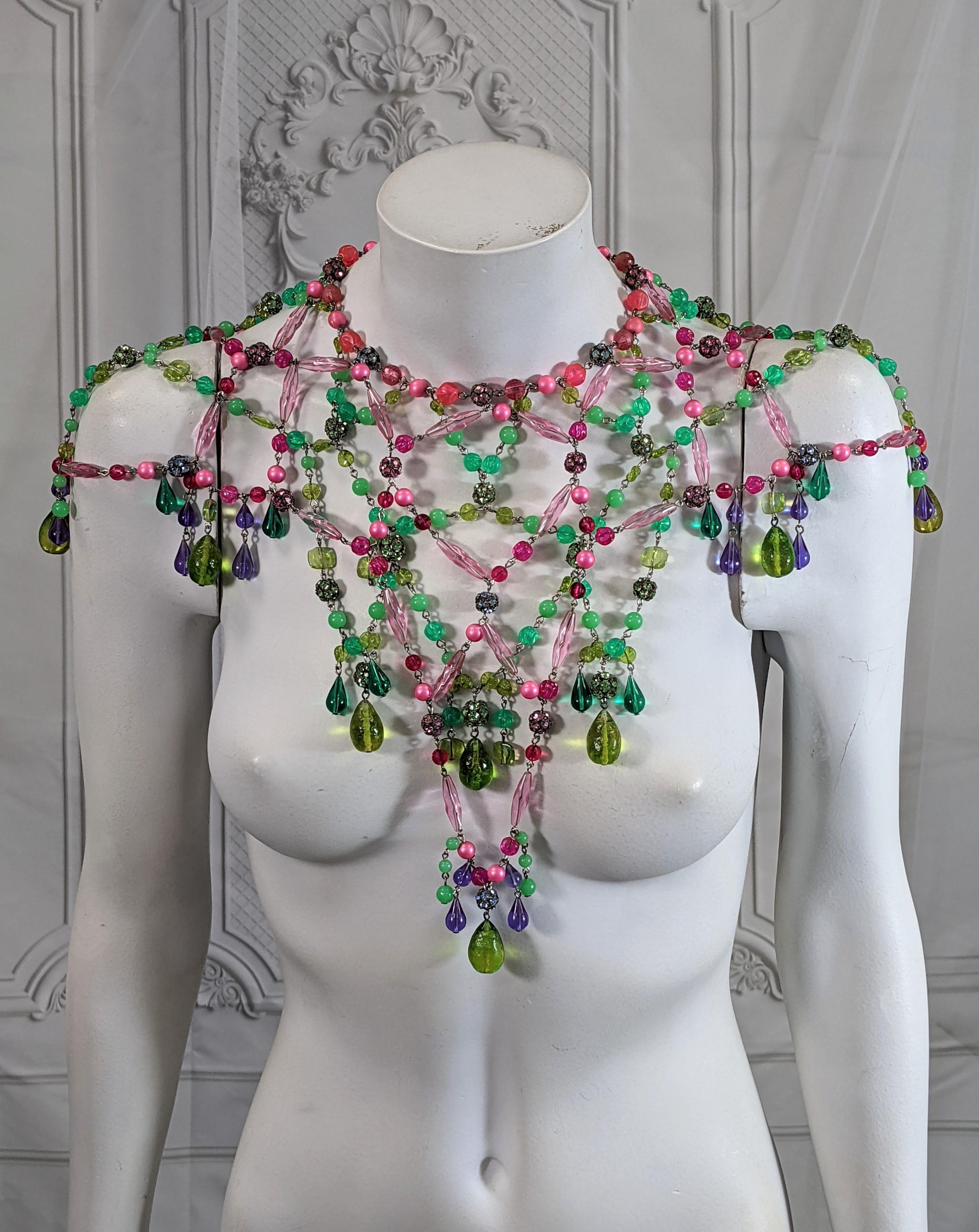 Dramatic bohemian capelet necklace from the 1960's USA. Handmade and composed of multicolored imported glass, resin beads and Swarovski crystal balls which form a capelet over shoulders. Wonderful colorations, perfect over a simple gown. 1960's