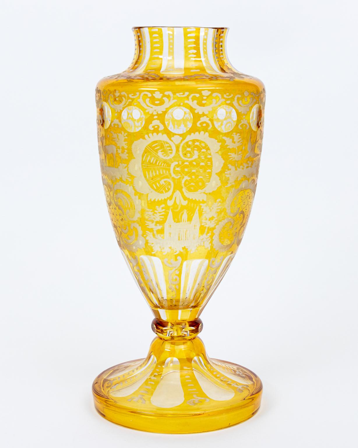 Vintage Bohemian etched vase in clear to yellow engraved with motifs of deer, cranes, castles, rabbits, and birds, circa 1900. Made in the Czech Republic. Please note of wear consistent with age. Excellent condition. 7.00 Inches base diameter.