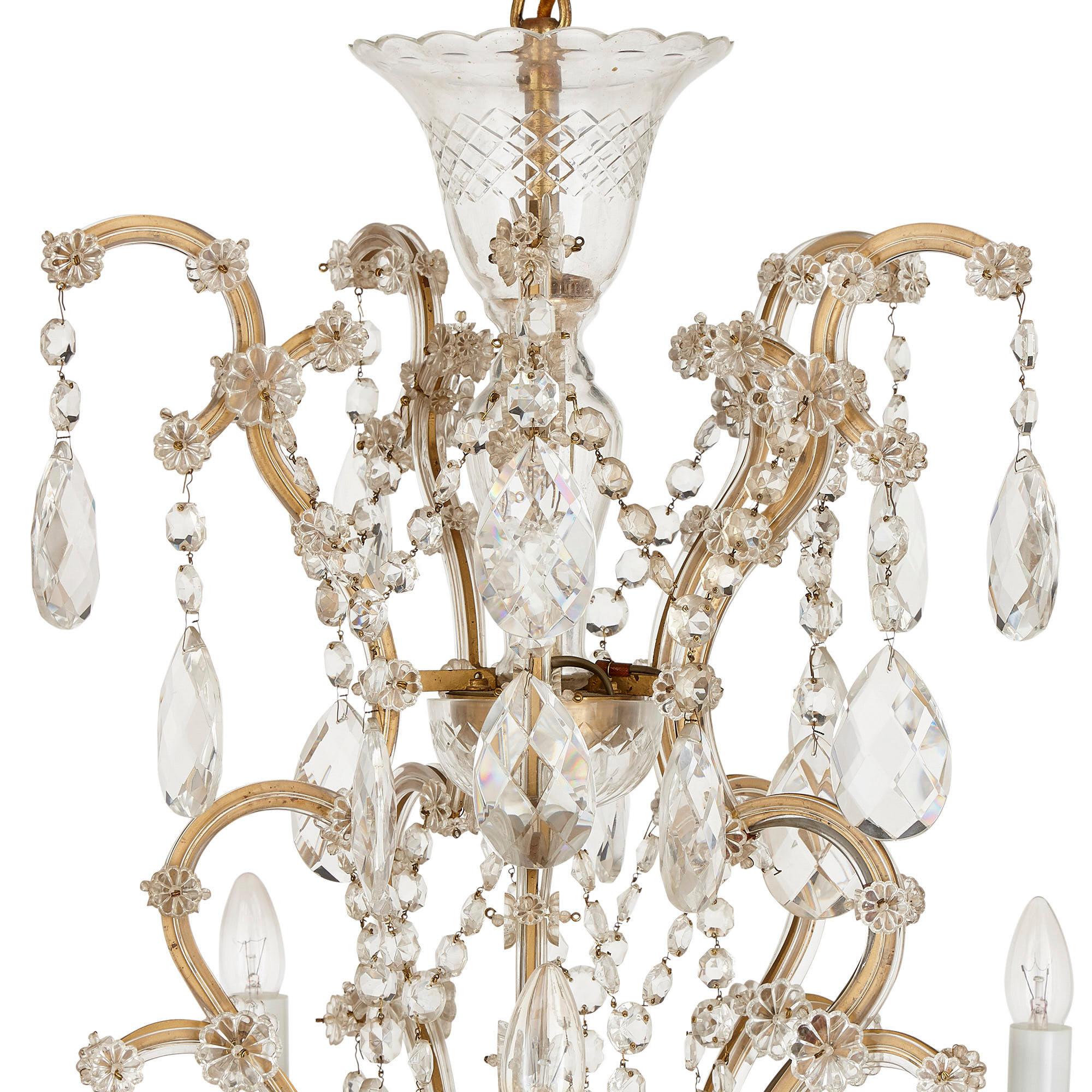 Bohemian facet cut glass Rococo style chandelier
Bohemian, 20th Century
Height 109cm, diameter 101cm

This luxurious chandelier is crafted in the Bohemian manner from wonderfully faceted cut glass. The chandelier features light branches arranged