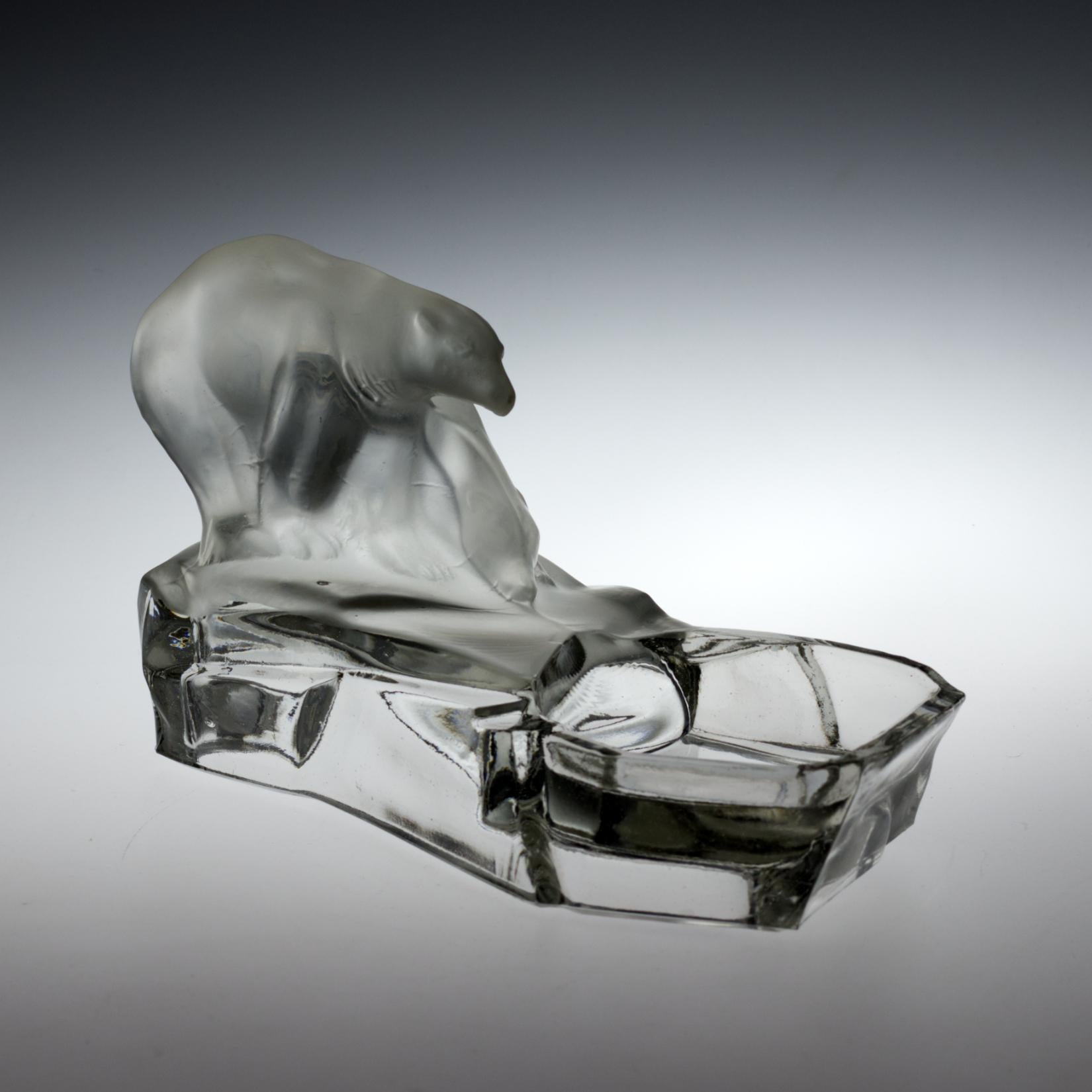 Made by Feigl and Morawetz Libochovice and designed by the Czech sculptor Karel Zentner. An antique figurative ashtray made out of clear pressed glass, partially frosted. Figurative scheme showing two polar bears sitting on an iceberg.
Measures: 24