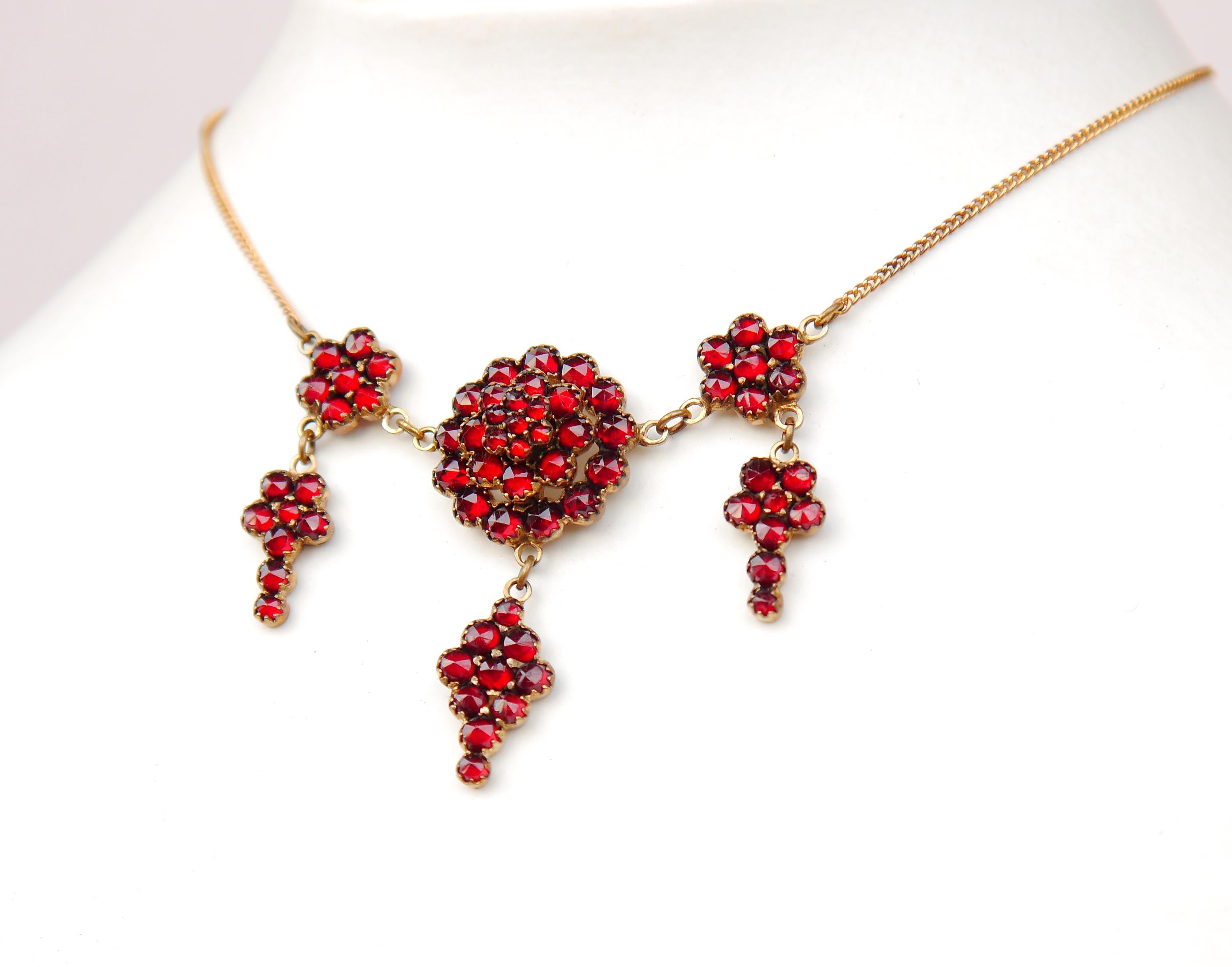
Austrian or Czechoslovakian Bohemian ca.  1920 - 1930s Garnet Necklace with pendants in Gilt Silver and chain in solid 18K Yellow Gold. No markings on pendant. Chain hallmarked 18K.

Plenty rose cut red garnet stones of gradual diameters. The