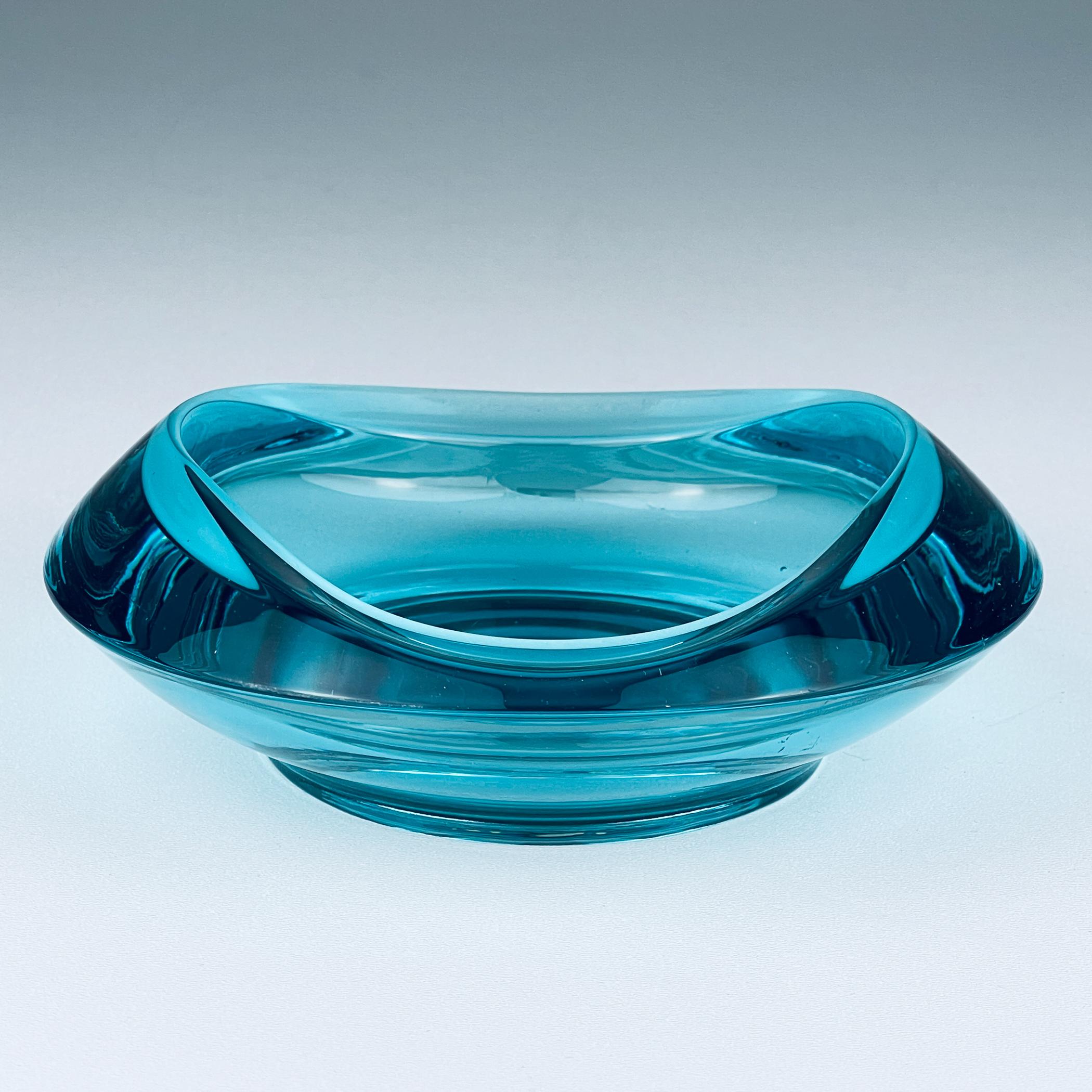 A stunning, stylish, and spectacular Bohemian glass ashtray / bowl made in the 1960s by Rudolf Jurnikl at the glass factory in Rozice, Union Sklo, Czechoslovakia. It is a large, curved, sculptural round piece made from pressed/molded colored glass