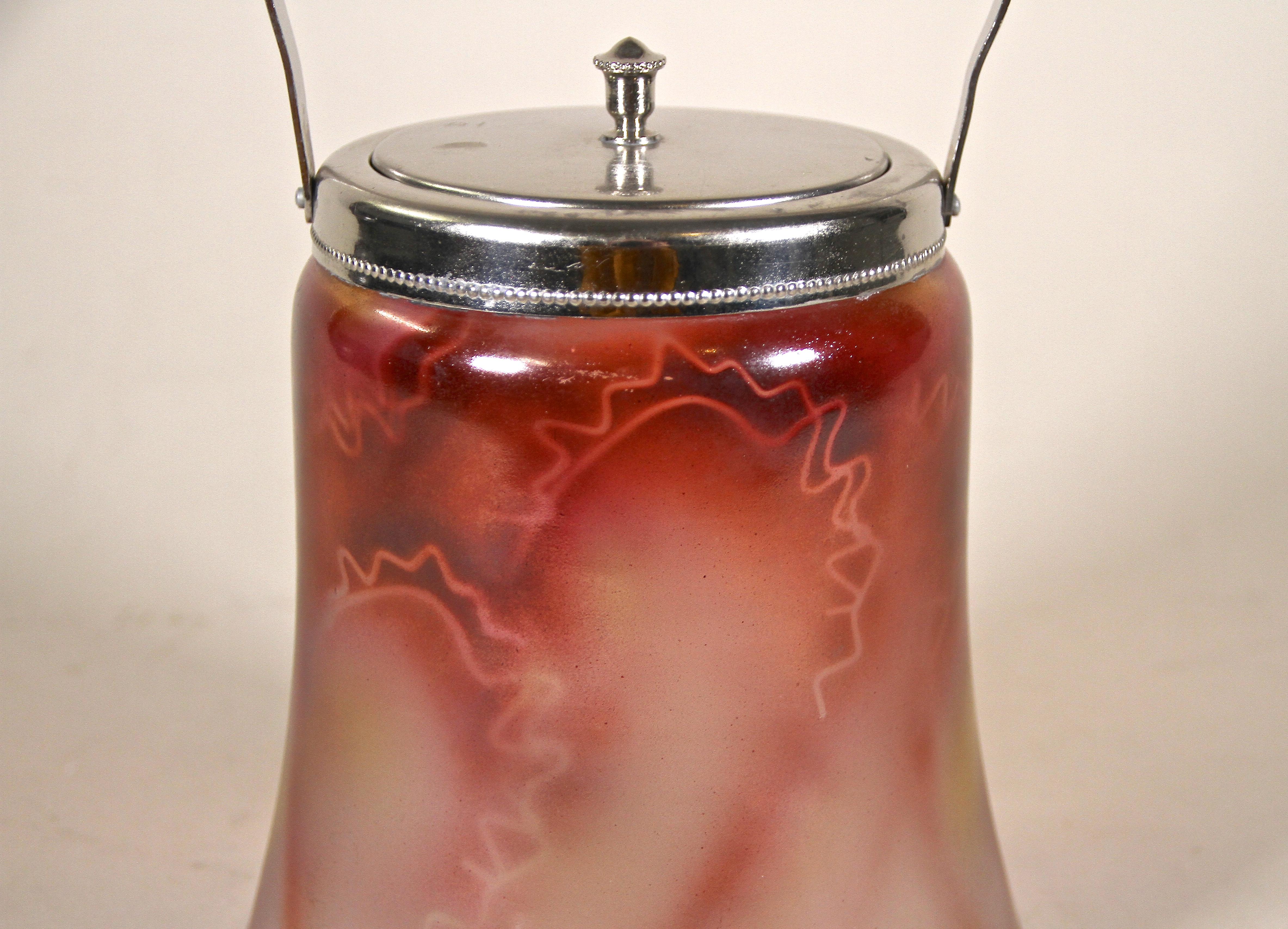 Unusual Bohemian glass Jar with lid from the Art Deco period in the Czech Republic around 1920. This beautiful shaped glass jar with handle comes with a removable lid and shows an extraordinary design with a coloration in red and yellow tones. This