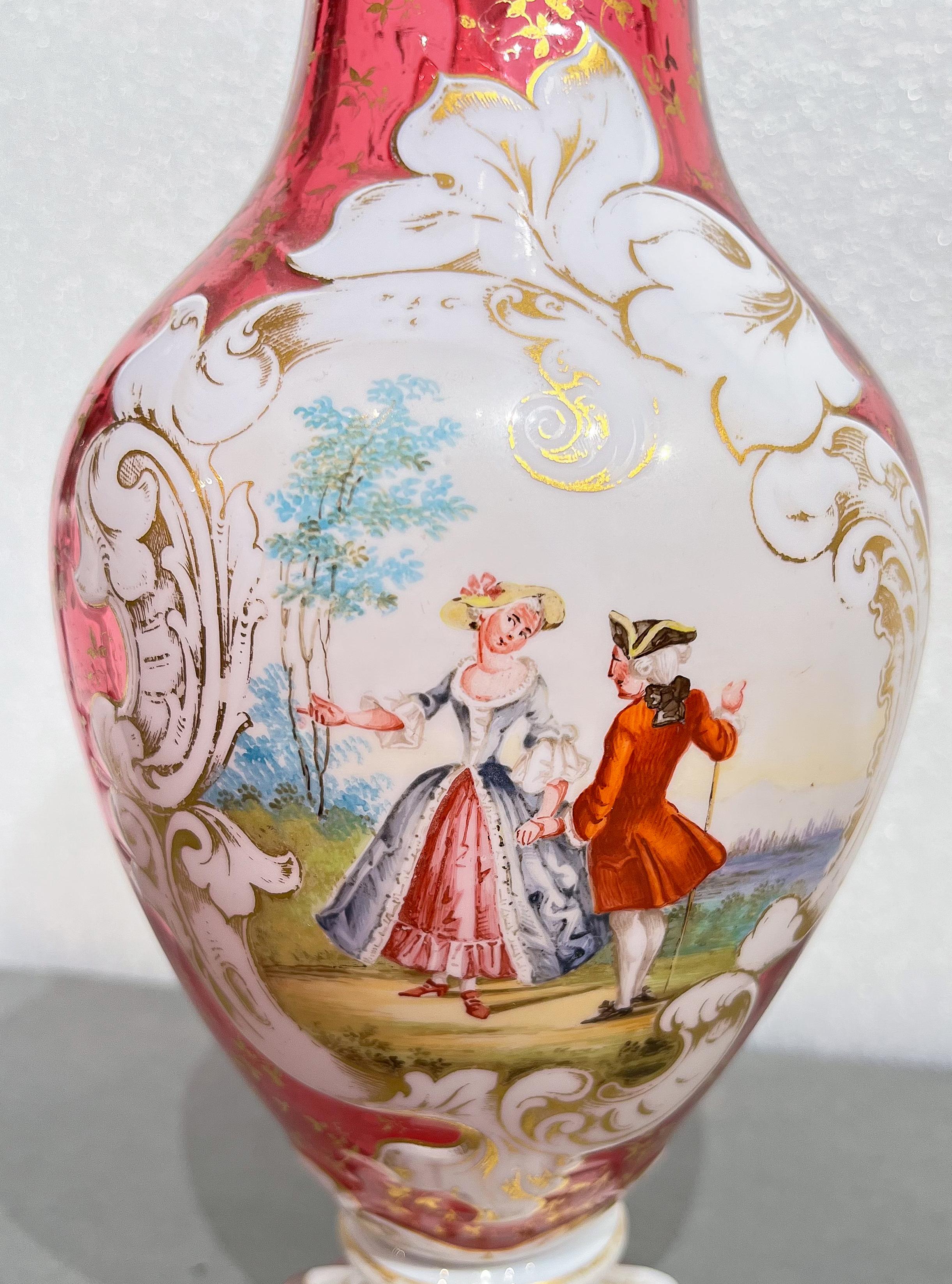 Handmade Bohemian watermelon glass pitcher with white enamel and jewel painted floral butterflies throughout. A sweet courting scene in a garden is hand painted on the enamel which is also accented with gold paint.

Origin: Czech Republic (Bohemia) 