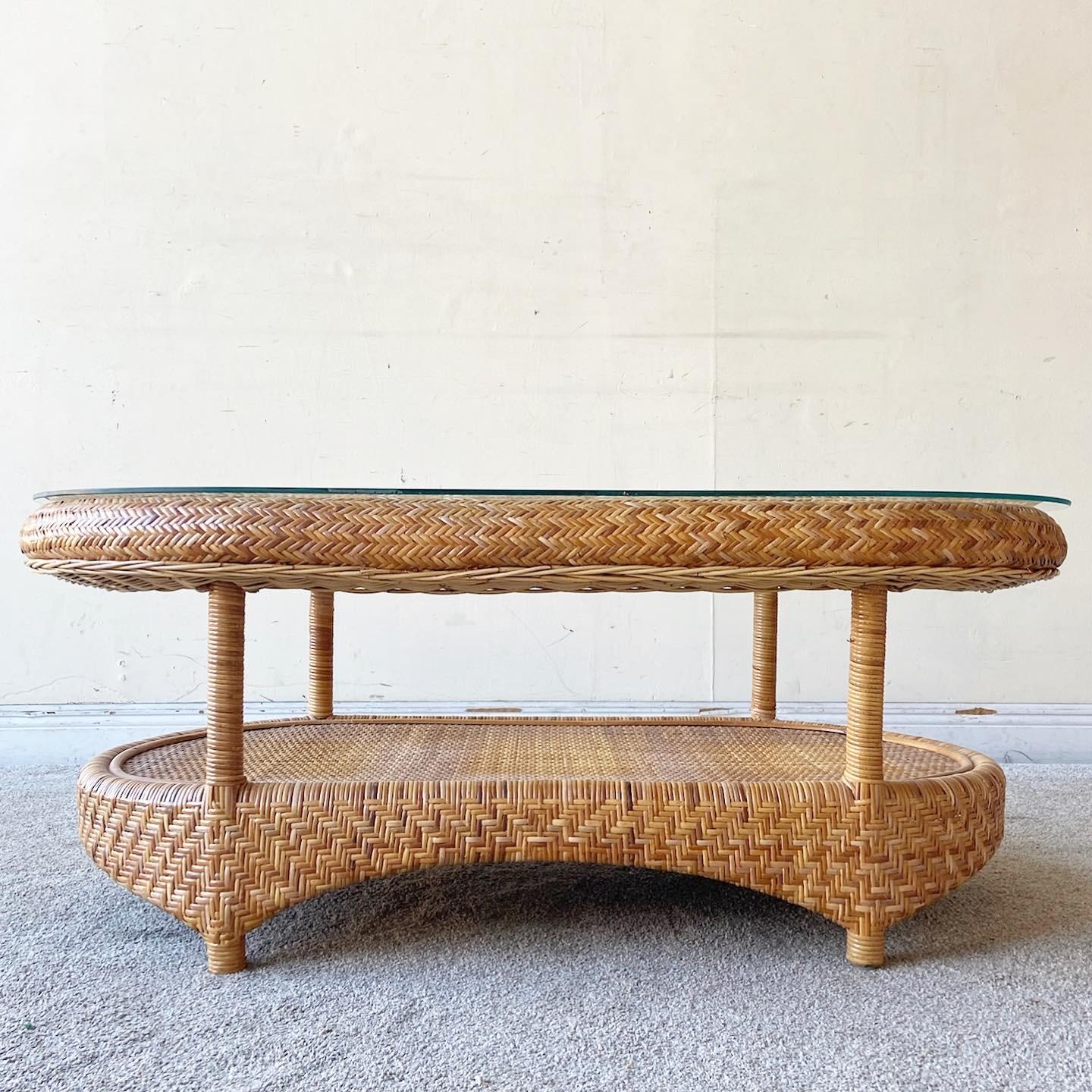 Exceptional vintage boho chic glass top coffee table. Features wicker weaving throughout the entire table surface.
  