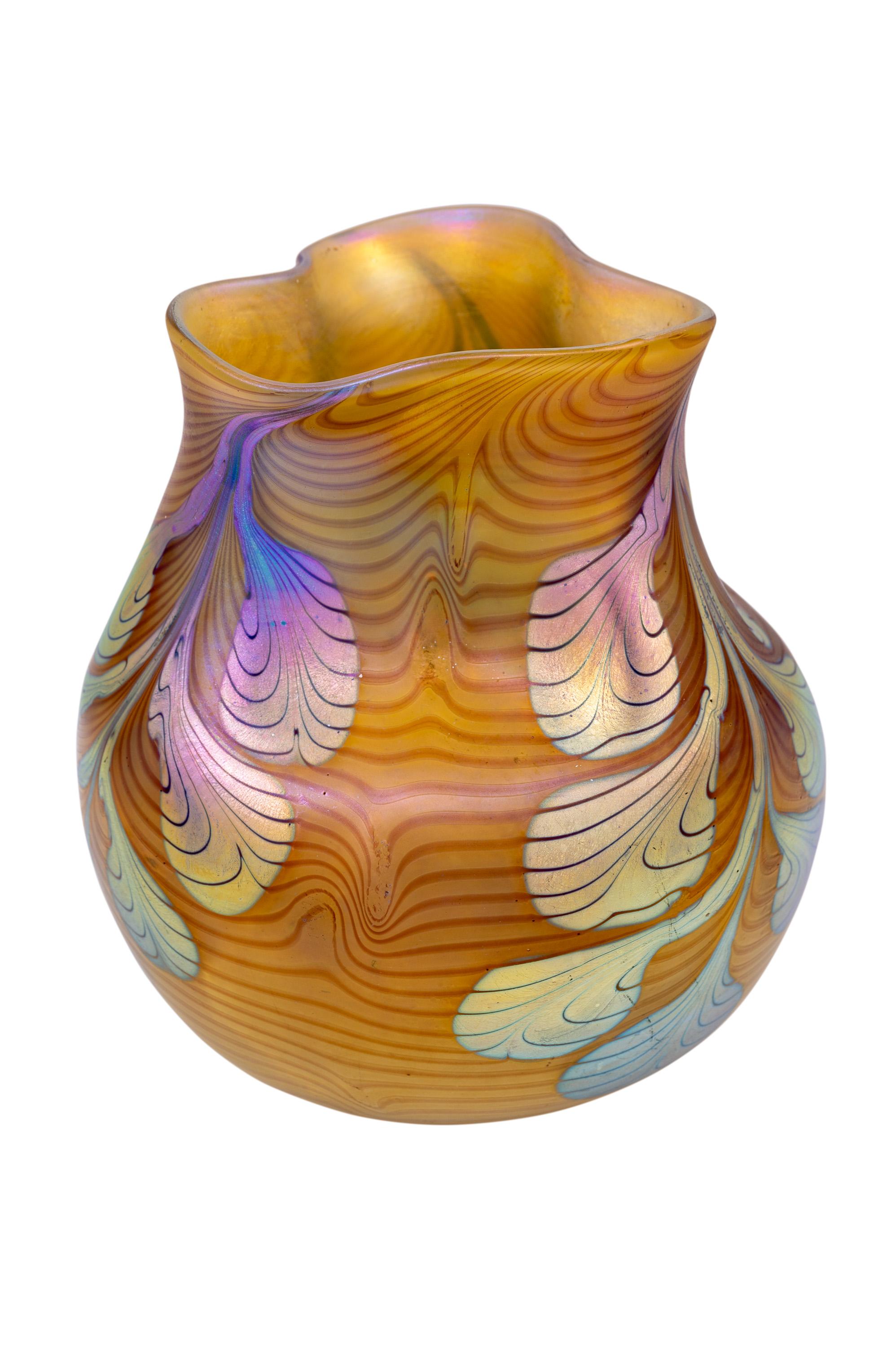 Vase, Johann Loetz Witwe, unidentified decoration, ca. 1903/04

Glass, mould-blown and freeform, reduced and iridescent

The first vases with stylized leaves were designed by Franz Hofstötter in 1900 for the World Exhibition in Paris. The strongly