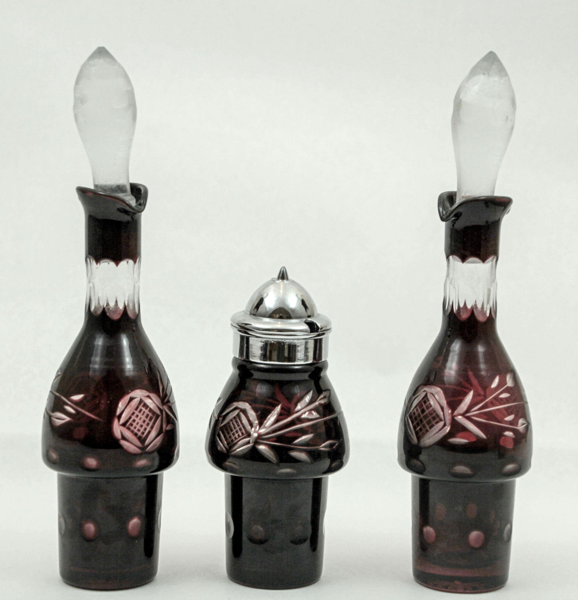 Bohemian Hand Cut Ruby Red Cut Crystal Condiment Cruet Set.
Set of three cut to clear Bohemian Art Glass ruby red pieces, two cruets with large crystal clear stoppers, one for olive oil, one for vinegar and one mustard pot with metal plate lid.
A