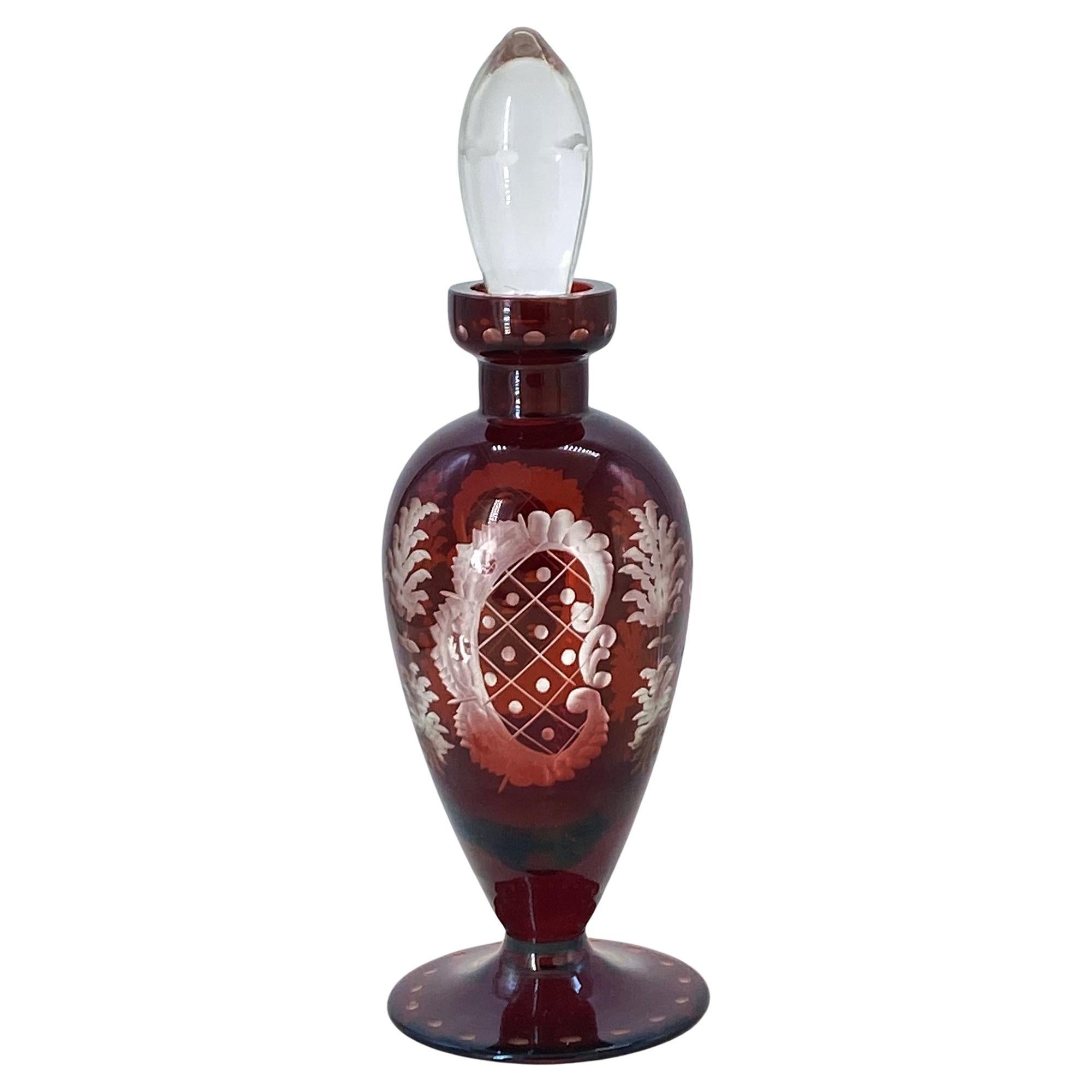 This is a bohemian ruby red perfume bottle. This hand cut to clear bottle have leaping reindeer, stylized 