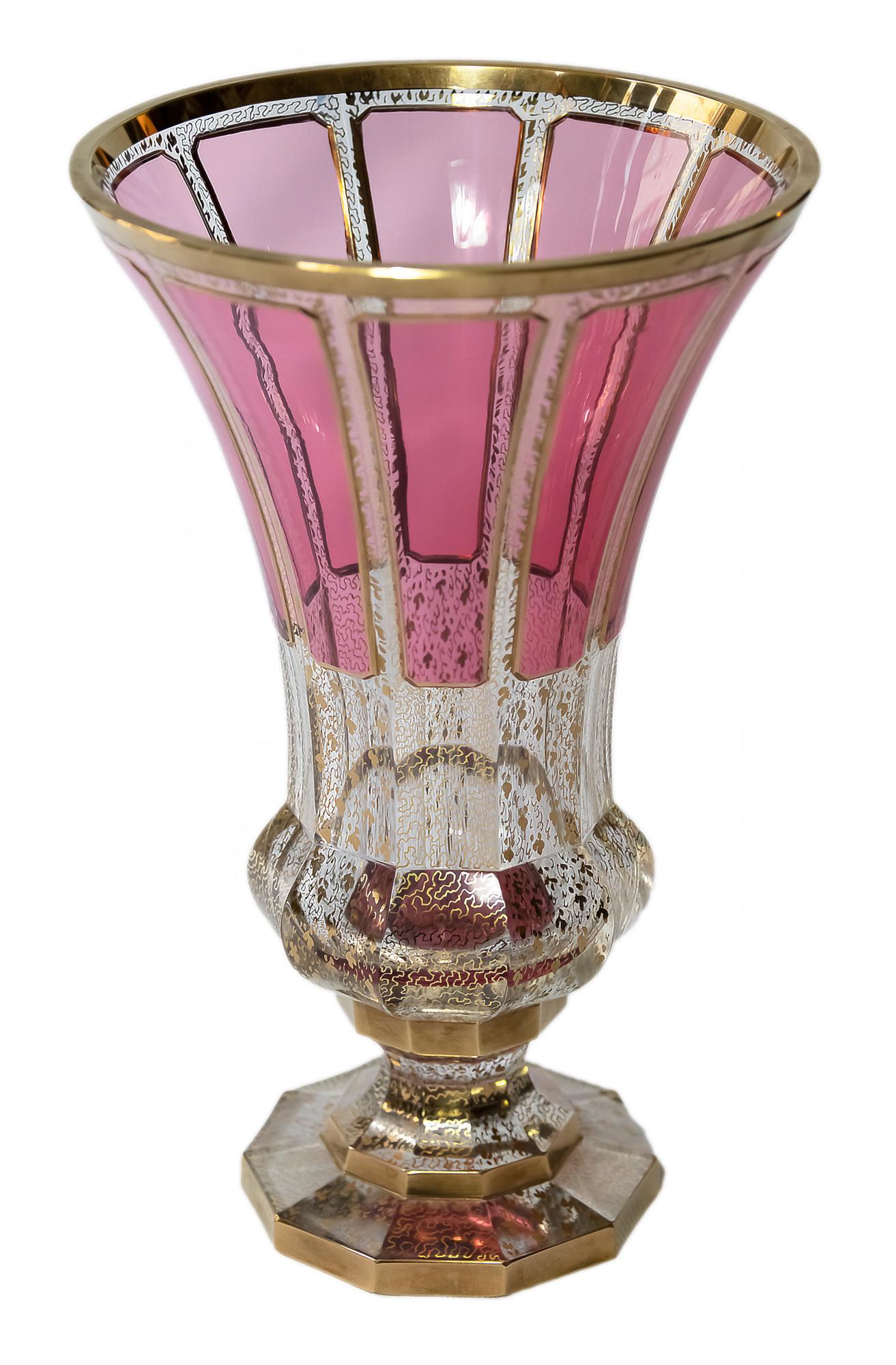 Bohemian transparent glass vase decorated with raspberry colour glass, gilt trims and gold pattern through the glass.
The vase is heavy and in a very good condition.