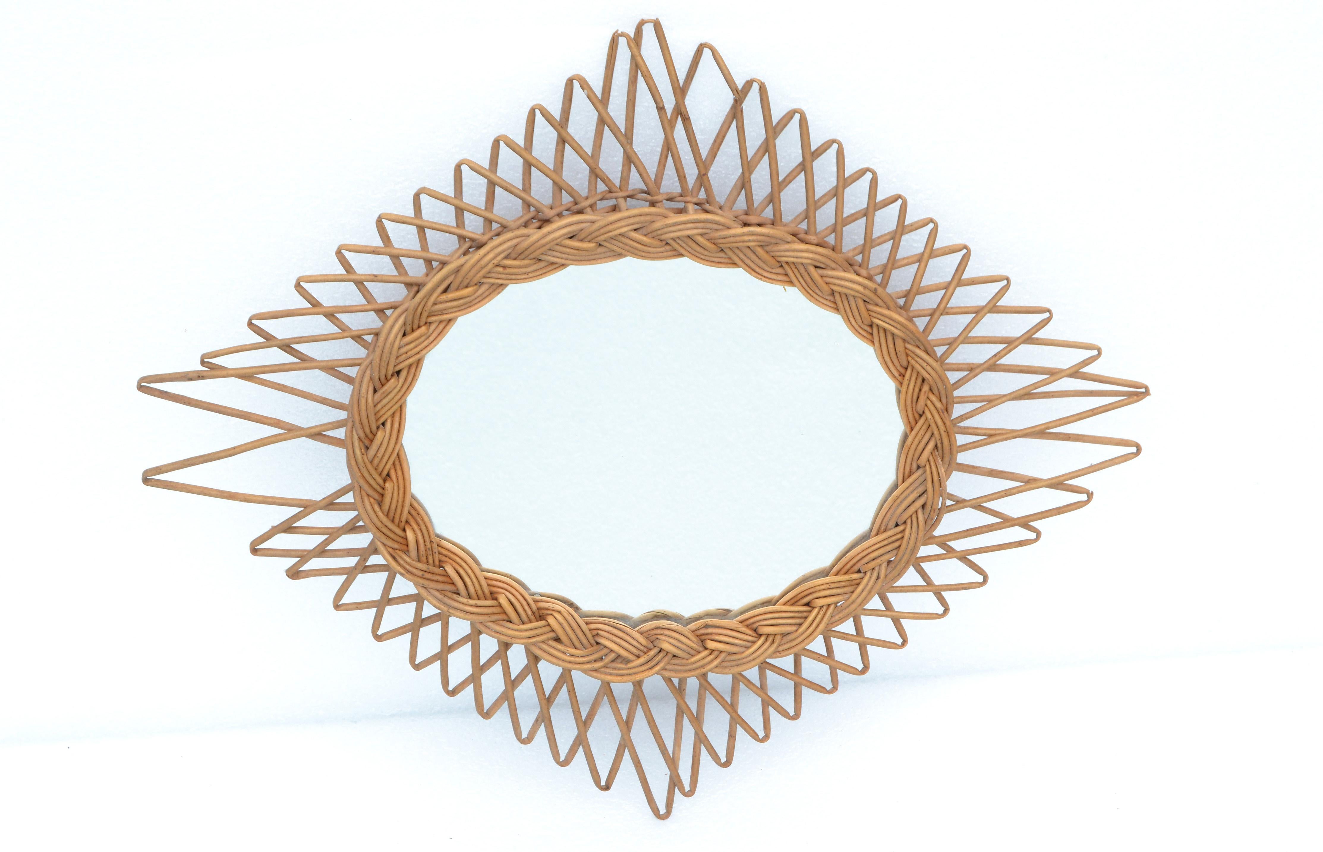 Mid-Century Modern wicker wall mirror in a handcrafted Rhombus shape.
Oval handwoven Bohemian Chic Folk Art mirror, made in France.
Can be hung horizontal and vertical. 
Mirror size: 8.25 x 10.5 inches.