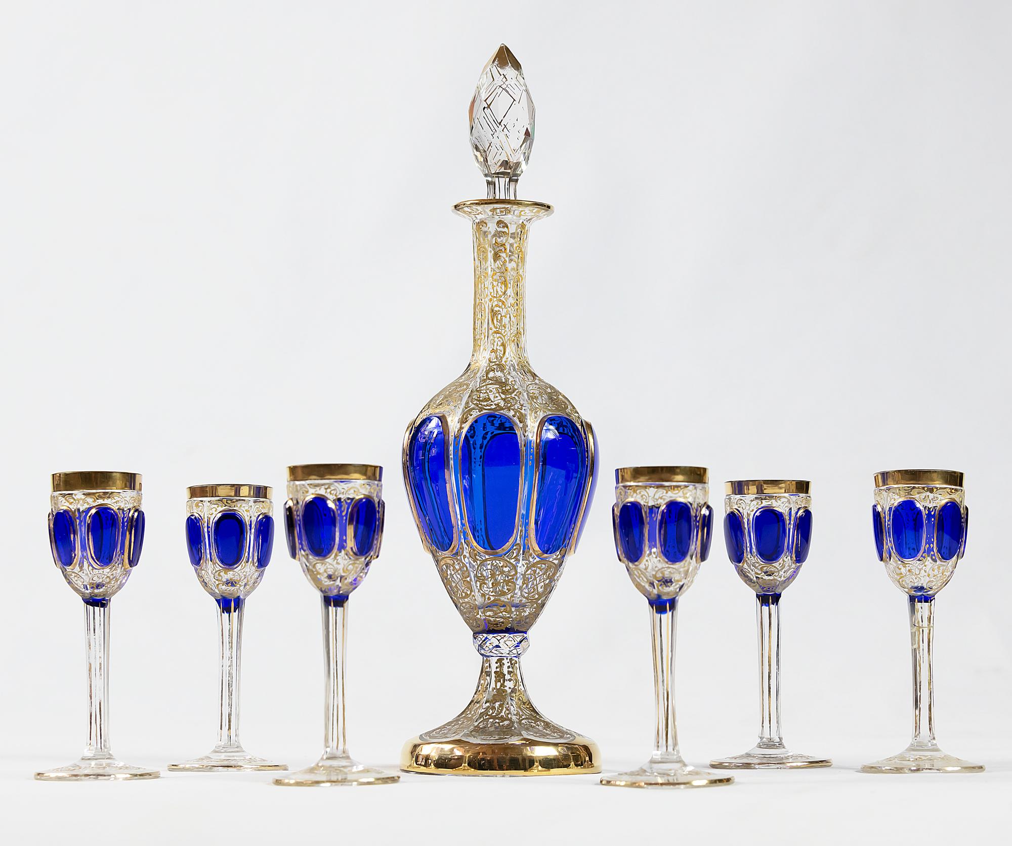 Antique Bohemian cut crystal liqueur set decorated with cobalt glass and hand painted in gold. The set includes 6 pieces of goblets, 1 piece decanter.
Very good antique condition. Except one goblet with small chip.
Decanter high 30 cm, goblet high