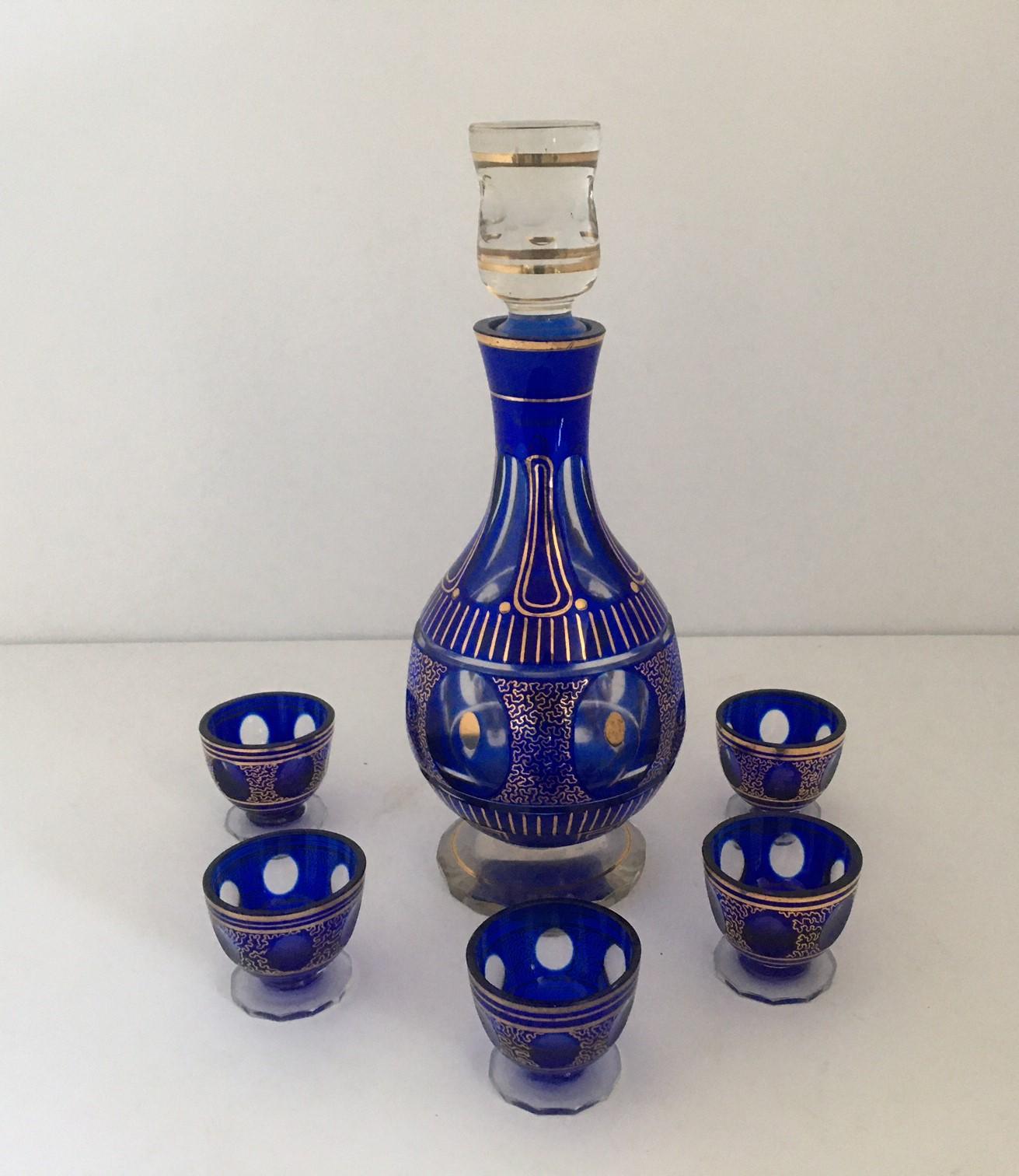 Bohemian cut crystal liqueur set decorated with dark purple glass and hand-painted in gold.
The set includes six pieces of goblets, and a one-piece decanter.
Very good condition.
Measures: Decanter 11.50