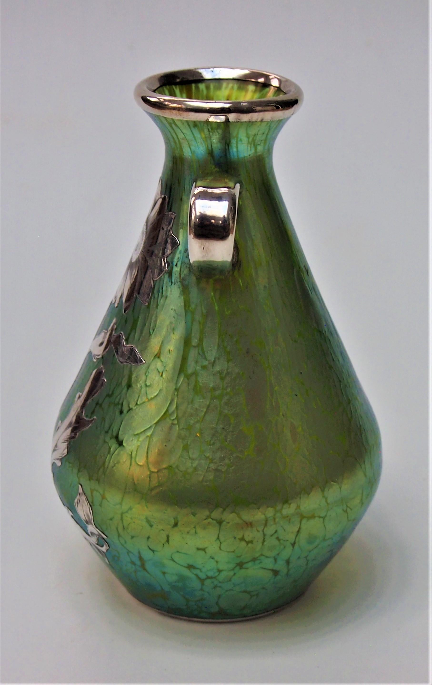 A fabulous Art Nouveau Loetz 'Crete' (blue/gold on green) Papillon (Butterfly wing) vase with applied handles and fine silver overlay. This iridised finish was first created by Loetz in 1898 and this is an early example. The fine silver overlay