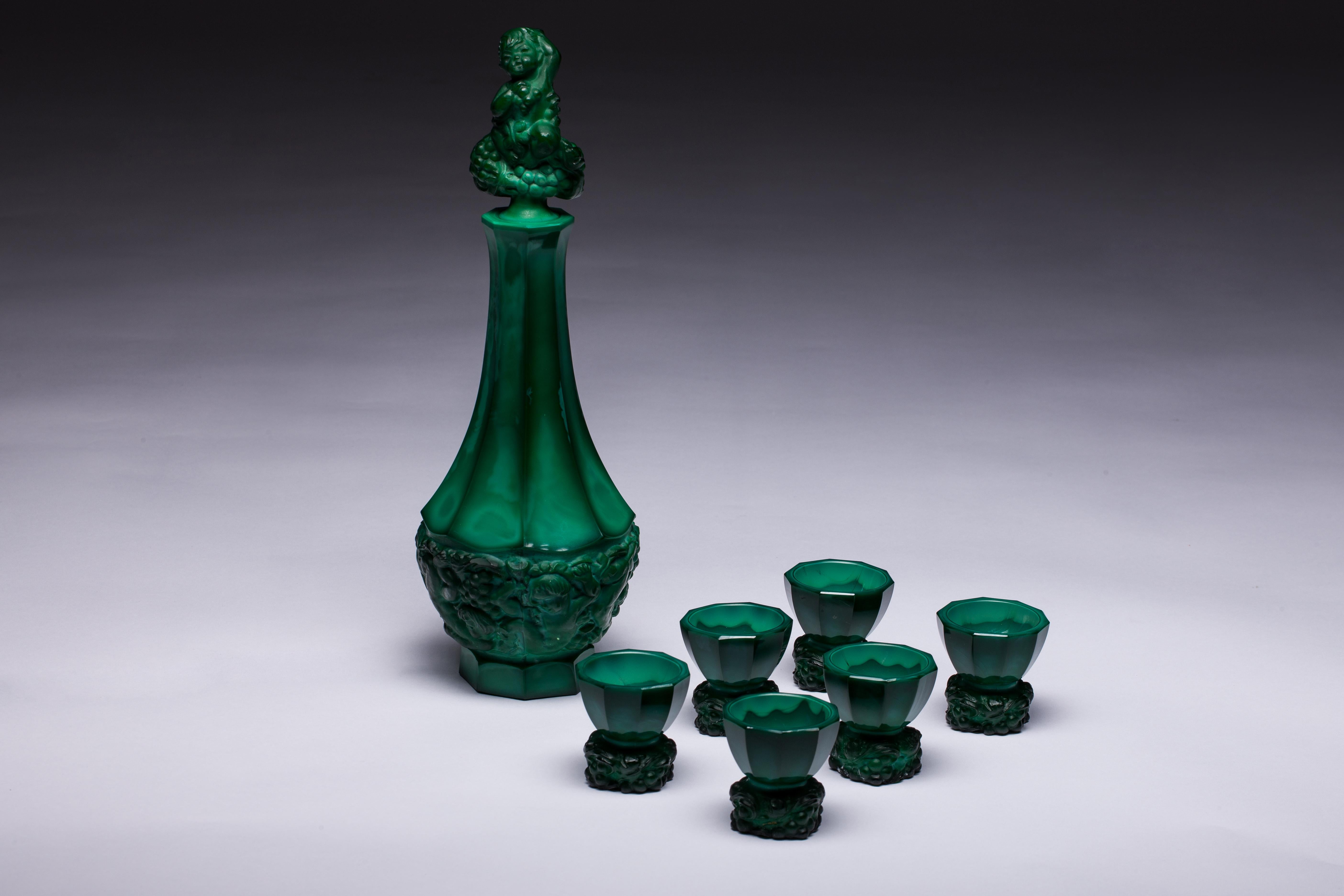 Czech malachite glass decanter with elaborate, decorative stopper and five matching glasses, circa 1930s. Sold and priced as a set. Decanter H 33.5 cm x D 12 cm. Glasses H 5.5 cm x D 5.5 cm.