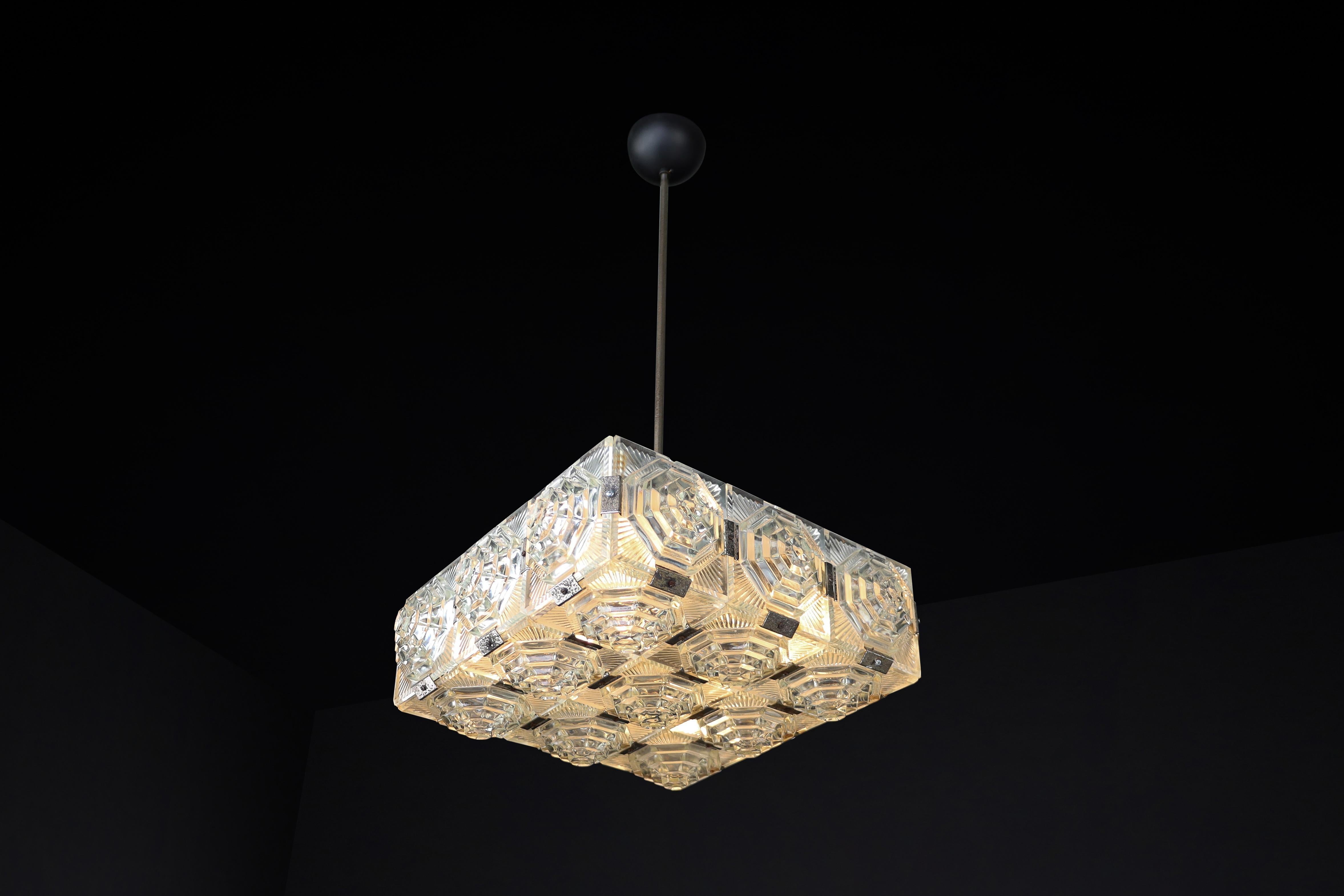 Bohemian Mid-Century Modern Glass & Chrome Chandelier, Czechoslovakia, 1970s – 21 Glass Elements, 

Restored (12+ Available, Priced Per Piece)

This rare Bohemian chandelier from 1970s Czechoslovakia is a beautiful expression of Mid-Century Modern