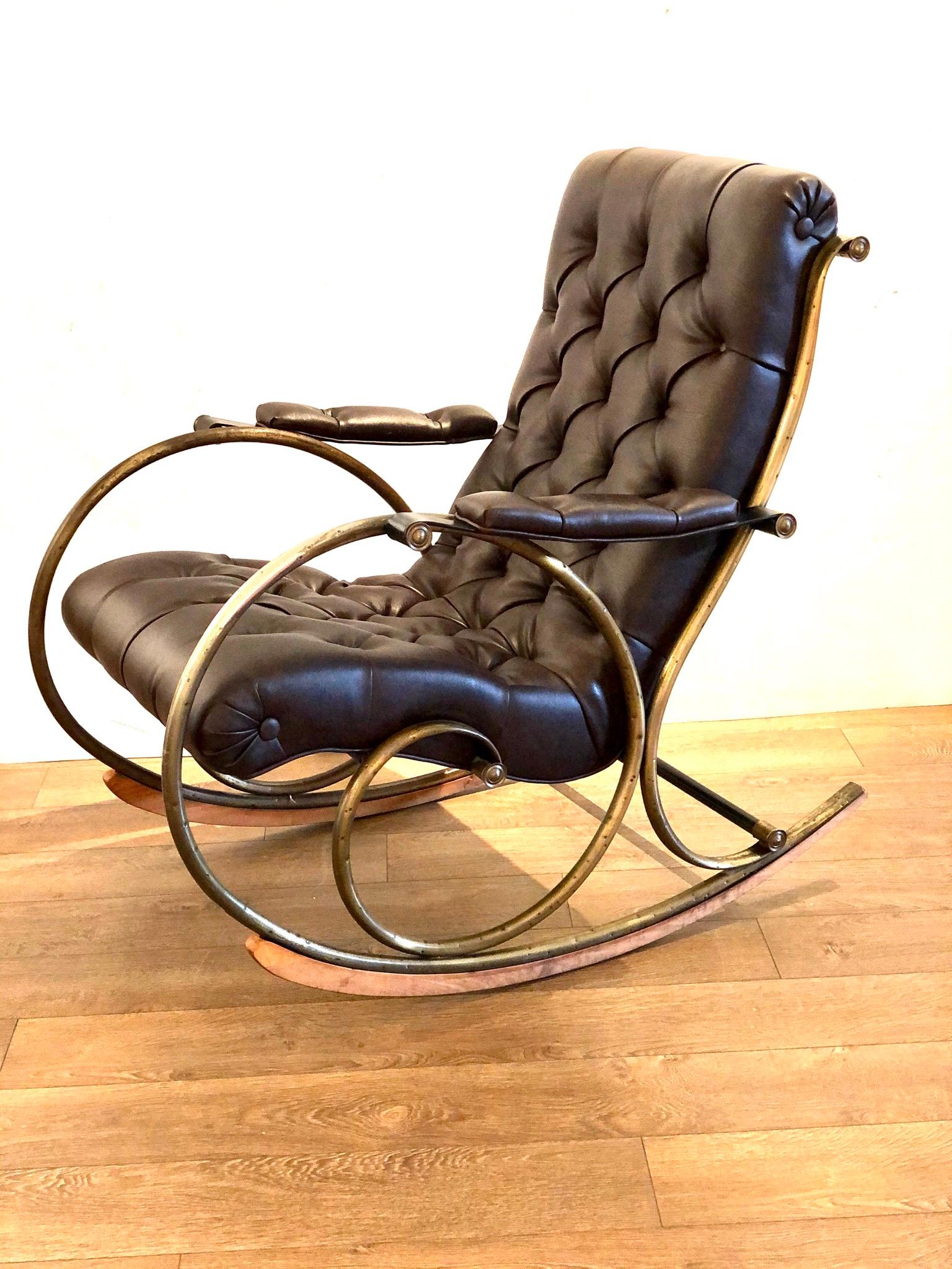 Beautifully designed sculptural rocker by Lee Woodard, with a tufted Naugahyde body and brass railing, circa 1950s in brown Naugahyde, very nice condition, the brass plating on the pipping its worn as shown and some finish its gone due to age, that