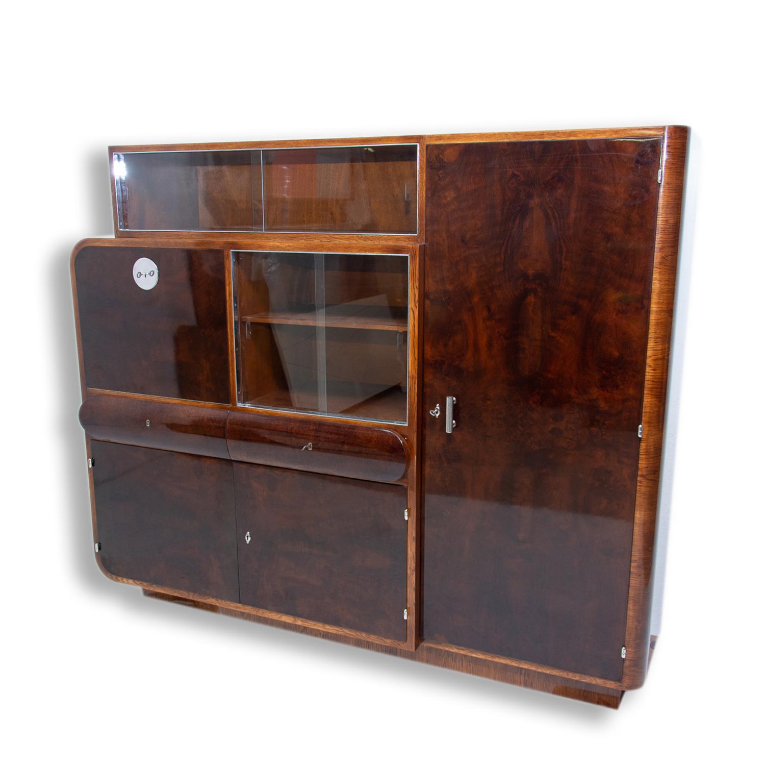 Bauhaus Art Deco oval cabinet. It can be used as a showcase, bookcase or sideboard. It was made in Bohemia in the 1930s. It was made by Urban Company - Bohemian pre-war furniture company.
The cabinet features glazed upper and middle part that can