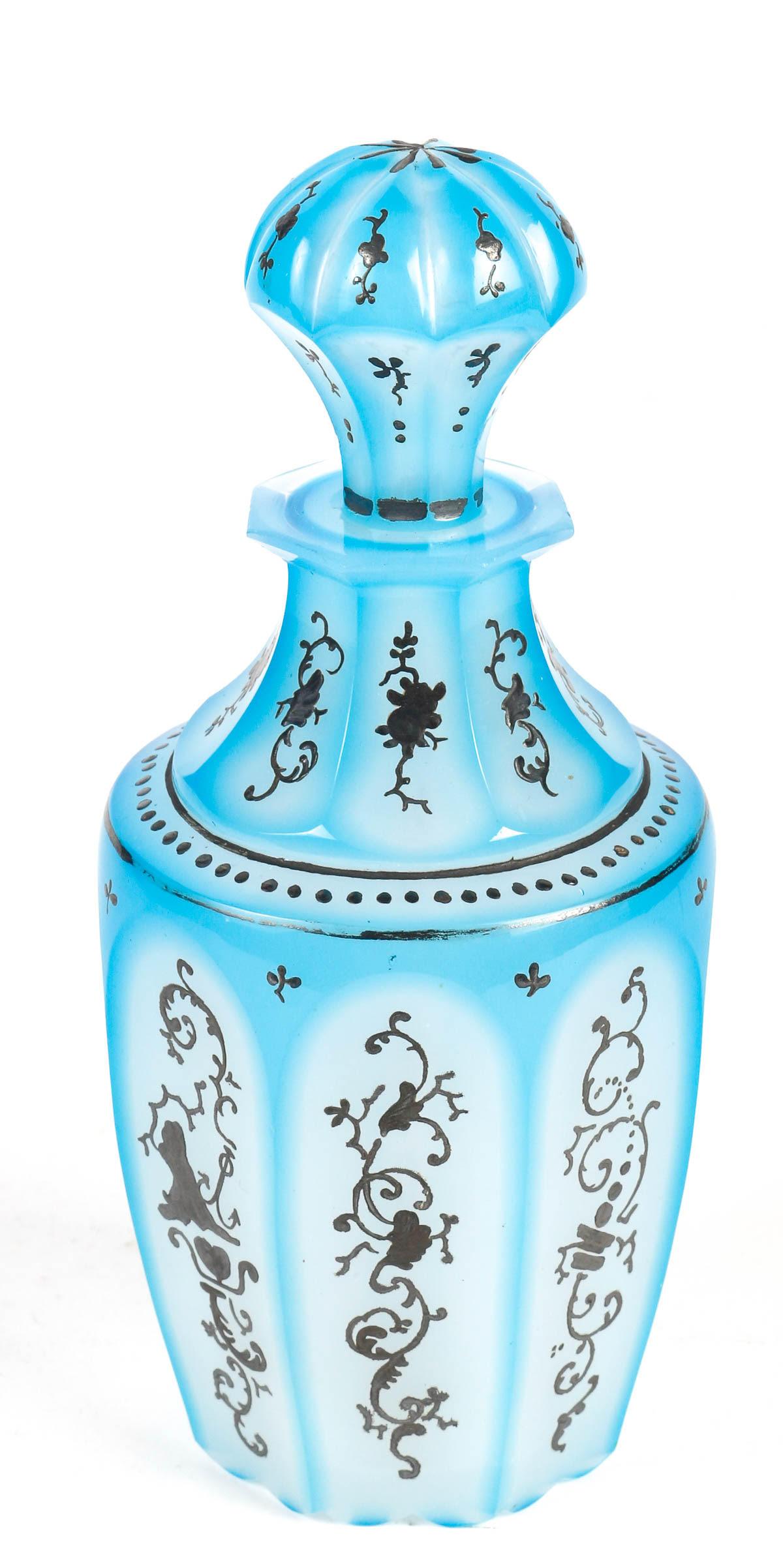 Bohemian opaline perfume bottle, 19th century.

A white and blue Bohemian opaline perfume bottle, silver enamelled, 19th century, Napoleon III period.    
h: 16cm , d: 7cm