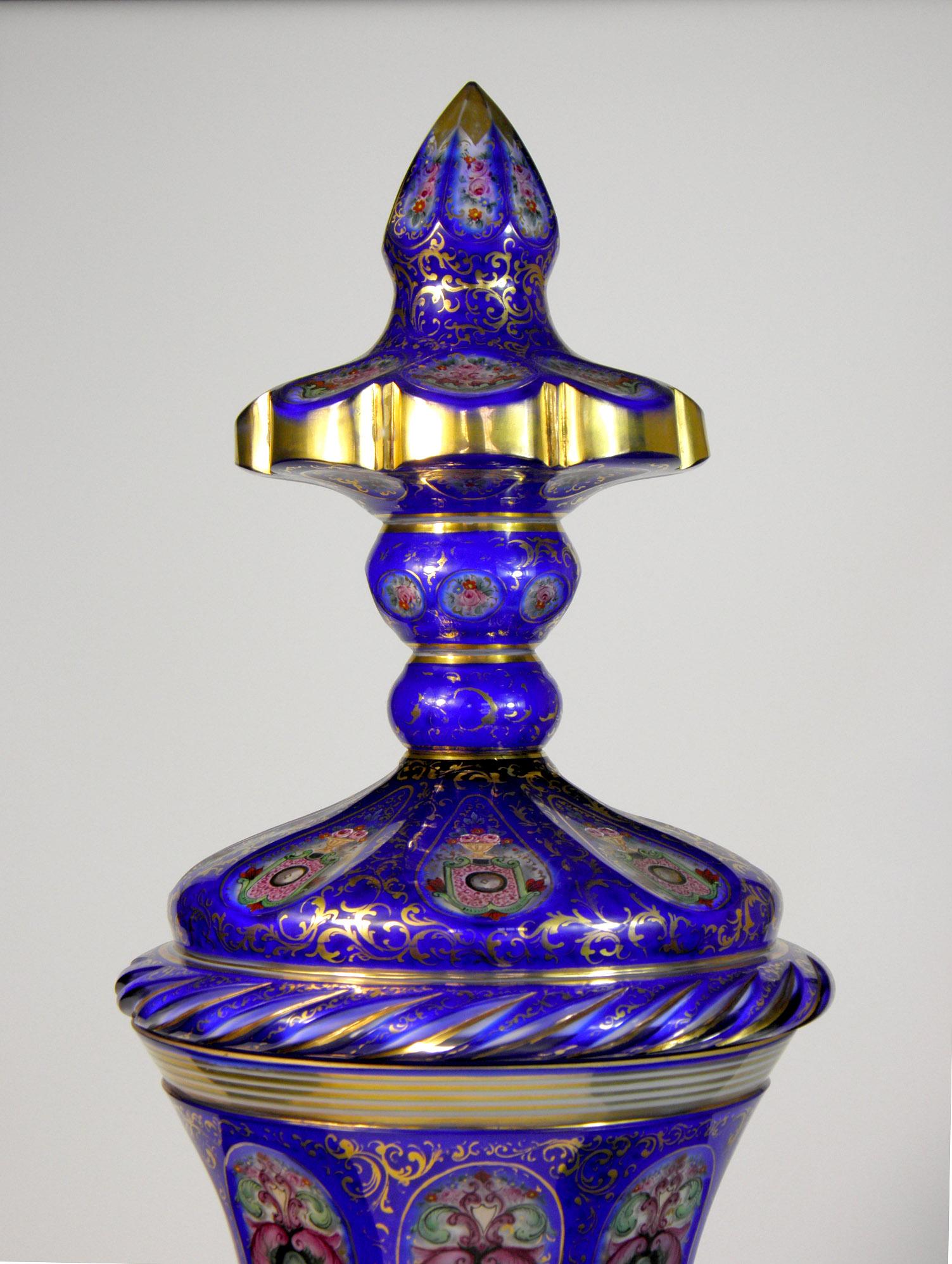 Large overlaid goblet with lid, cobalt and opal glass. Cut, painted ornamental and floral motif, colors and gold, the leg of the cup is cut, which is a very demanding and interesting work, which makes the cup very interesting, the cup is also